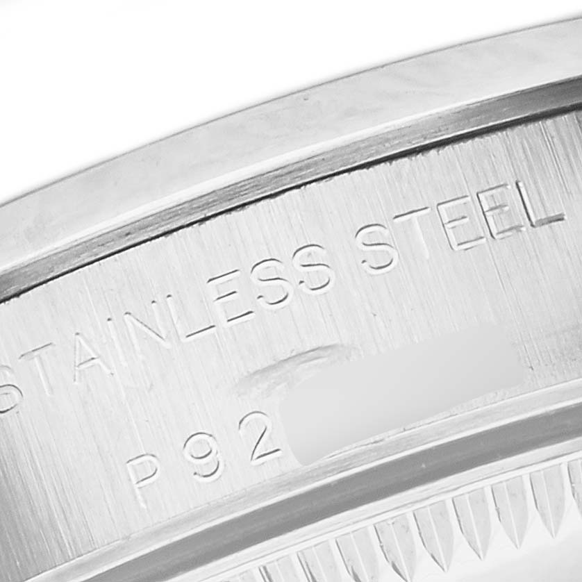 This image shows a close-up of the back casing of a Rolex Oyster Perpetual 76080 Women's Stainless Steel Black Dial 76080 Women's Stainless Steel Black Dial watch, highlighting its stainless steel material.