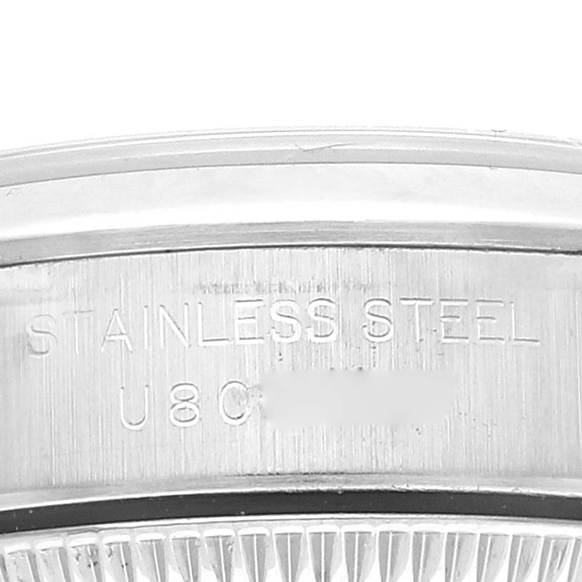 This image shows a close-up of the stainless steel engraving on the case back of the Rolex Oyster Perpetual 67180 Women
s Stainless Steel Blue Dial 67180 Women
s Stainless Steel Blue Dial watch.