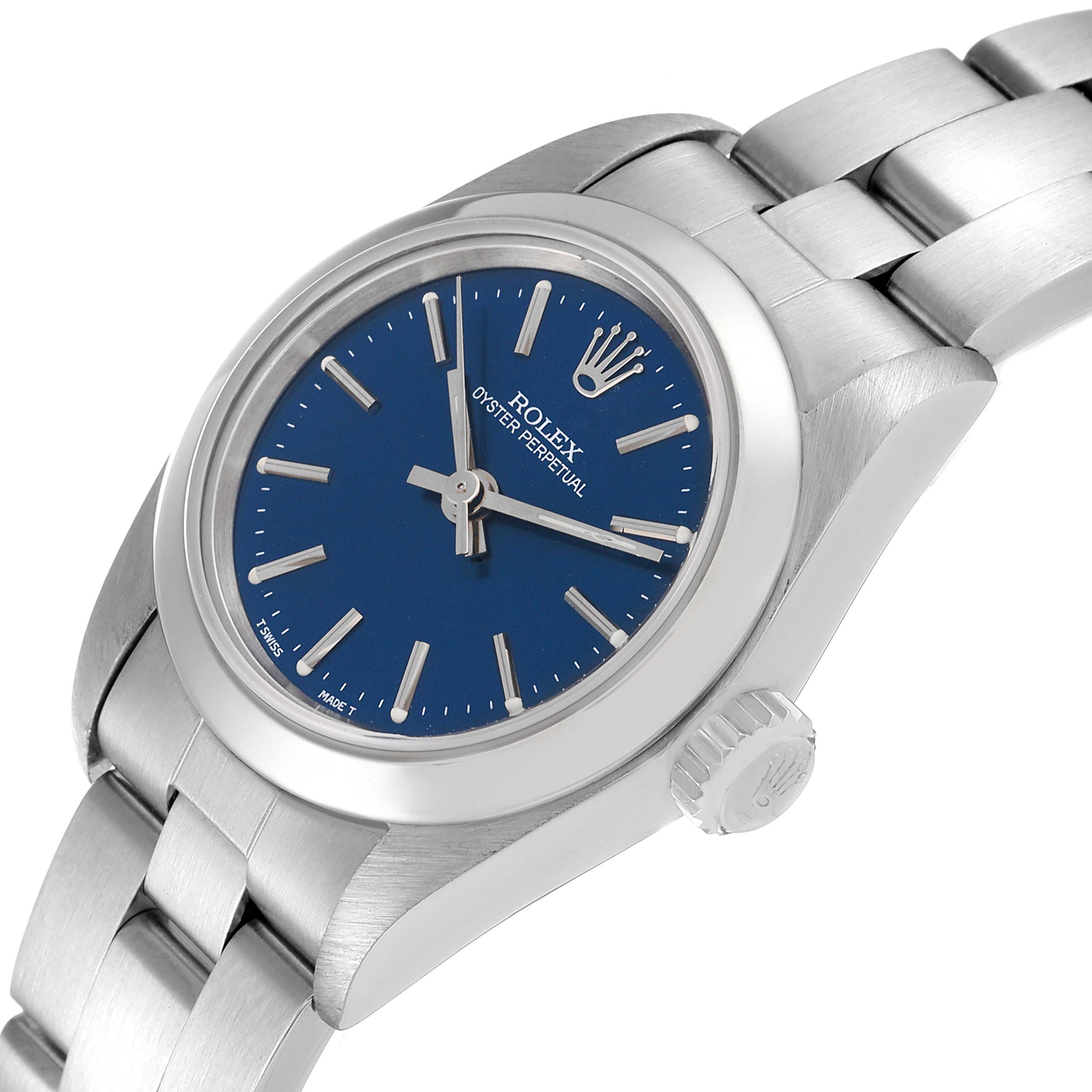 The image shows a Rolex Oyster Perpetual 67180 Women
s Stainless Steel Blue Dial 67180 Women
s Stainless Steel Blue Dial watch at a three-quarter angle, highlighting its blue dial, crown, case, and metal bracelet.