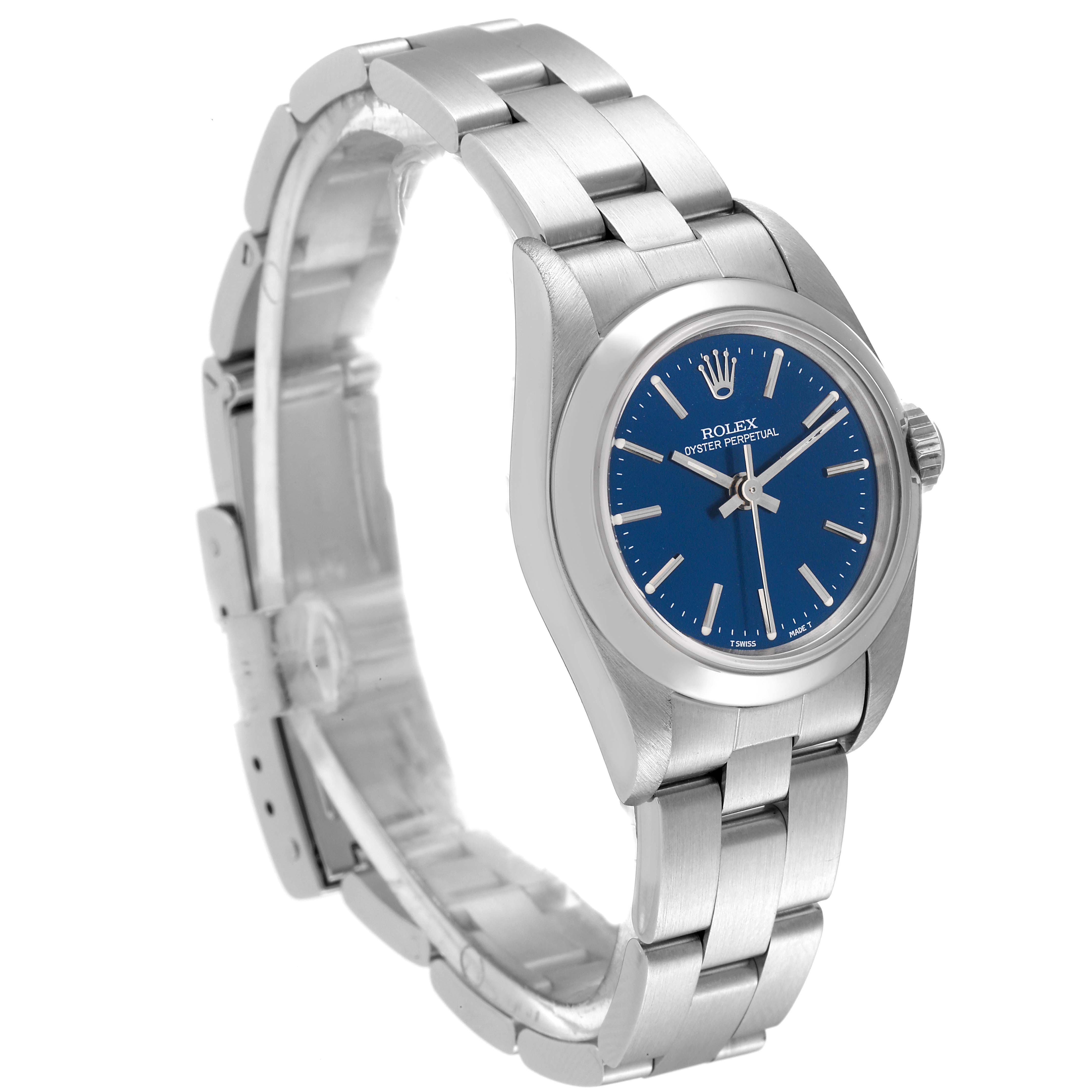 The Rolex Oyster Perpetual 67180 Women
s Stainless Steel Blue Dial 67180 Women
s Stainless Steel Blue Dial watch is shown from a three-quarter side angle, highlighting its blue dial and silver bracelet.