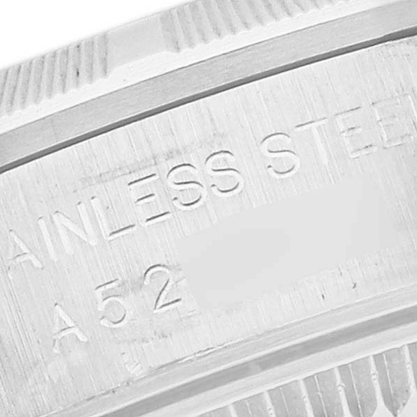 The image shows a close-up of the stainless steel case back rim of the Rolex Oyster Perpetual 76030 Women's Stainless Steel Pink Dial 76030 Women's Stainless Steel Pink Dial watch, highlighting engraved text.