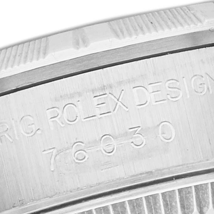 The image shows a close-up of the case edge with the serial number and text on the Rolex Oyster Perpetual 76030 Women's Stainless Steel Pink Dial 76030 Women's Stainless Steel Pink Dial watch.
