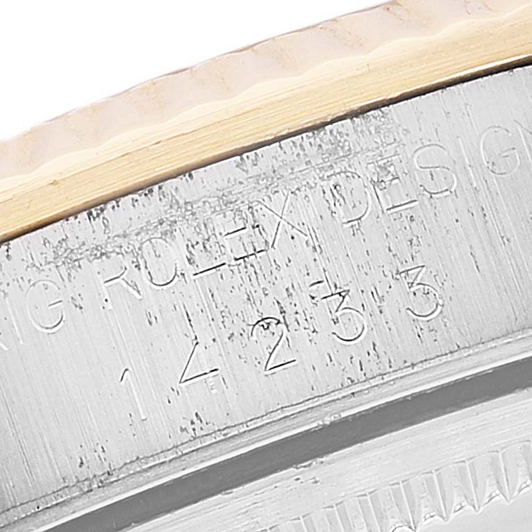 This image shows a close-up angle of the outer rim and engraving details on a Rolex Oyster Perpetual 14233 Men
s Steel and Gold (two tone) White Dial 14233 Men
s Steel and Gold (two tone) White Dial watch.