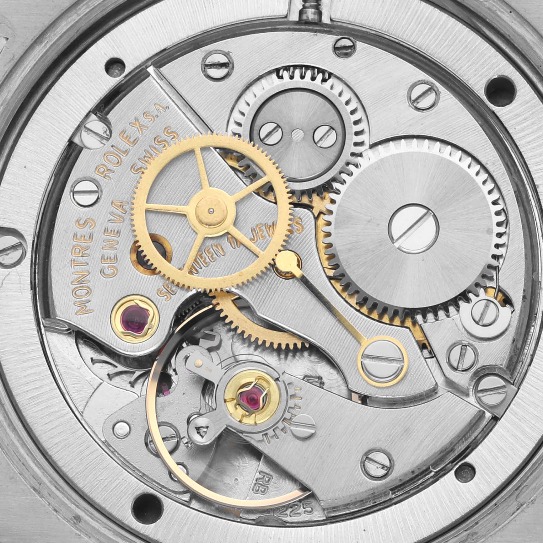 The image shows the intricate internal movement of a Rolex Date 6694 Men's Stainless Steel Silver Dial 6694 Men's Stainless Steel Silver Dial watch, featuring gears and jewels.