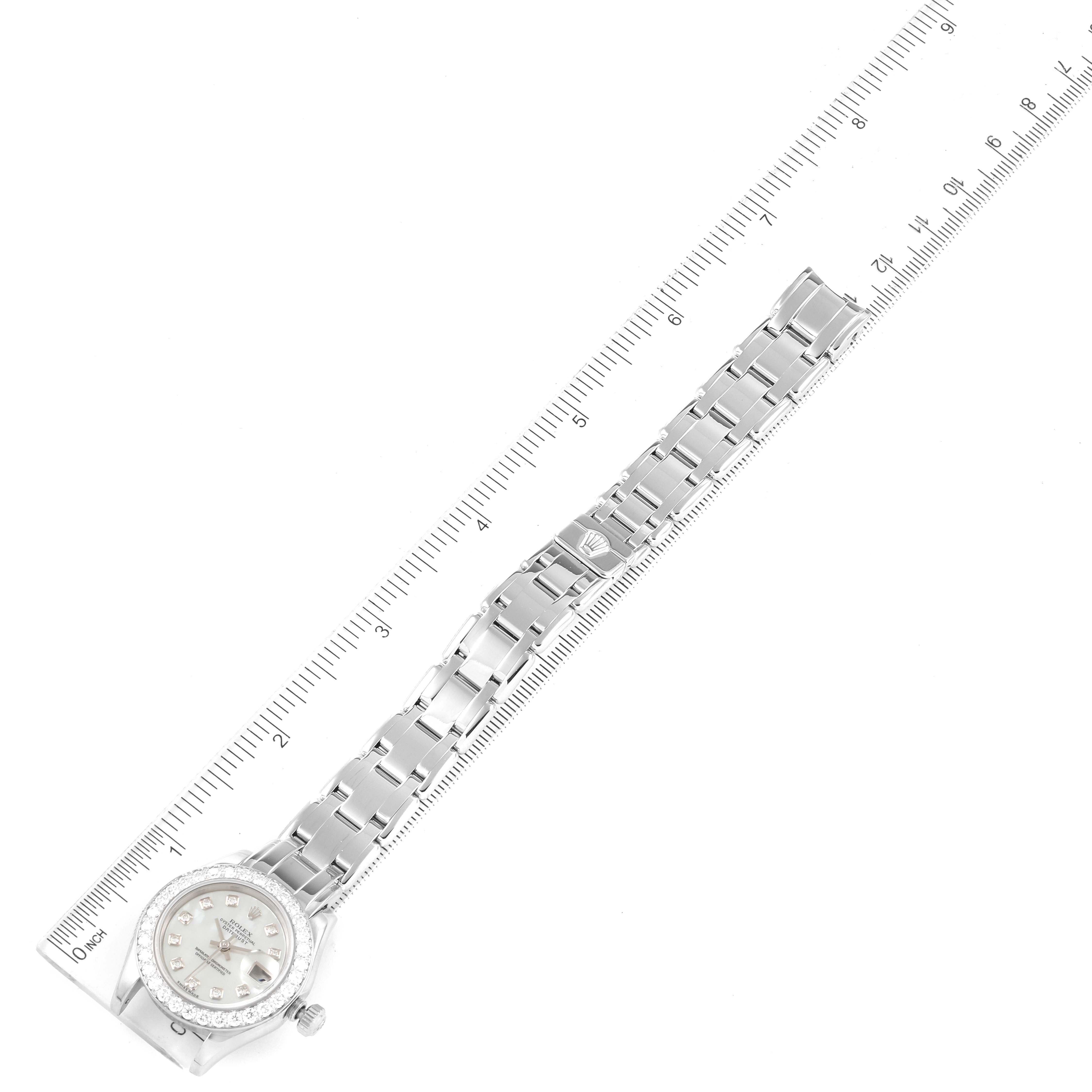 This image shows a top view of a Rolex Pearlmaster 80299 Women's White Gold Mother of Pearl Dial 80299 Women's White Gold Mother of Pearl Dial watch, highlighting its face, bezel, and bracelet alongside a ruler for measurement.