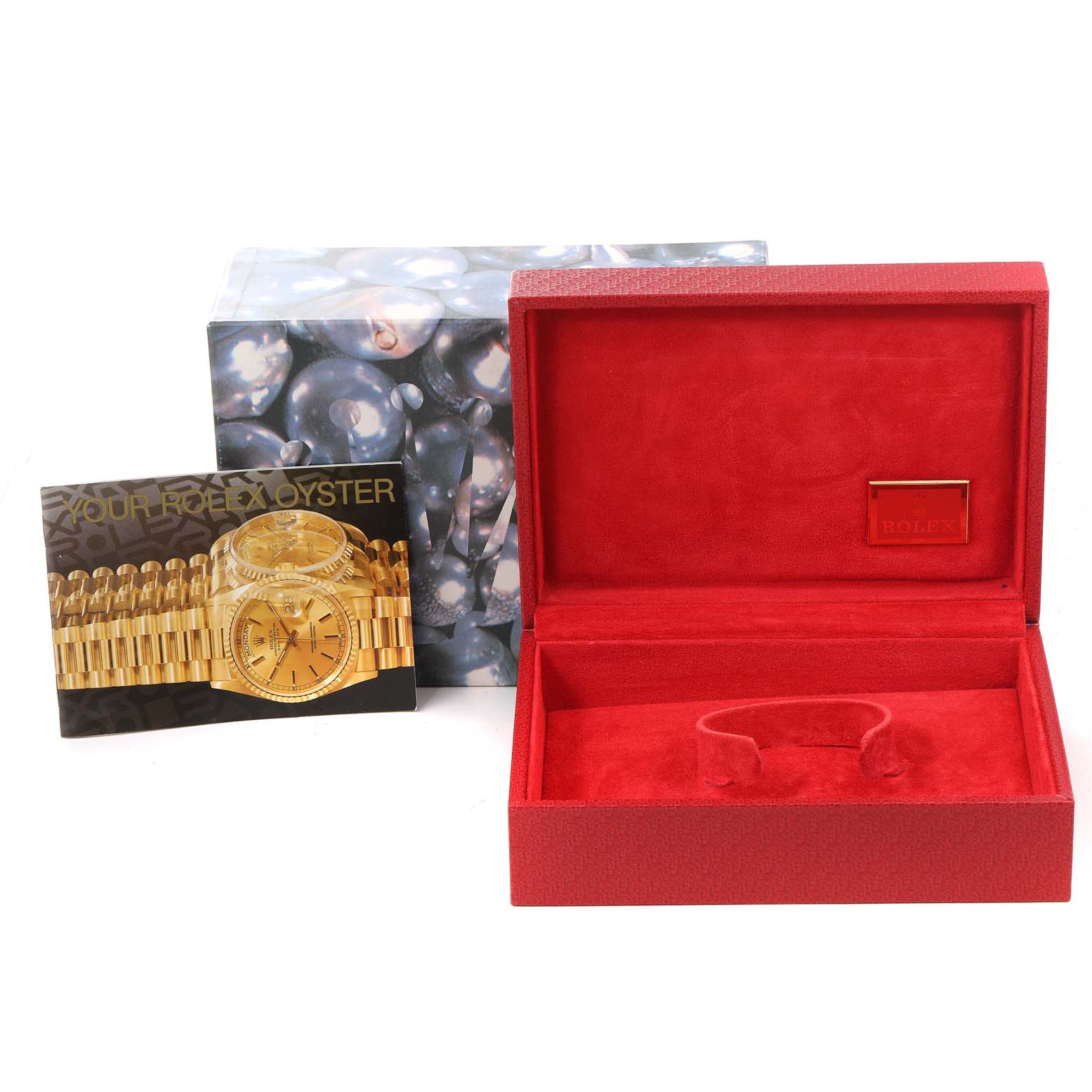 The image shows a red Rolex Pearlmaster 80299 Women's White Gold Mother of Pearl Dial 80299 Women's White Gold Mother of Pearl Dial watch box, an outer sleeve with a pearl design, and a product booklet.
