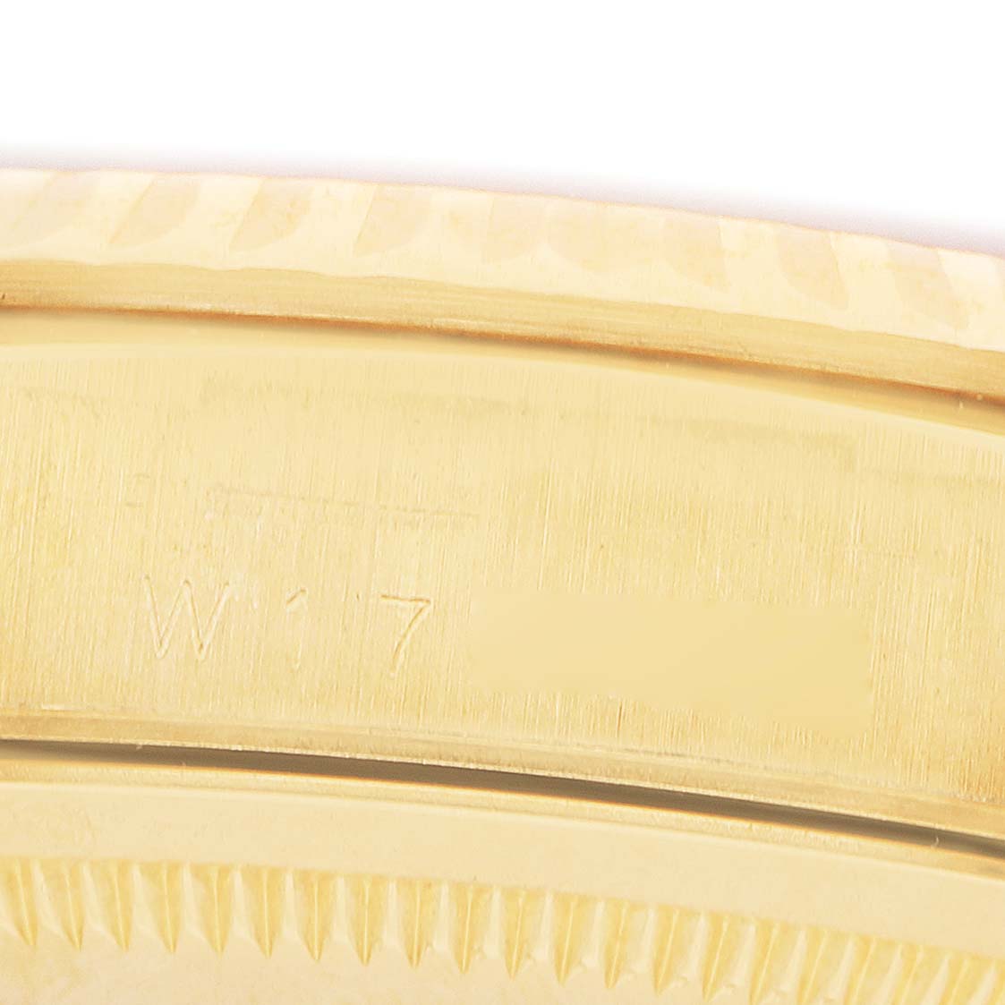 The image shows a close-up of the gold-toned bezel edge and serial number engraving on a Rolex GMT-Master 18238 Men's Yellow Gold Champagne Dial.