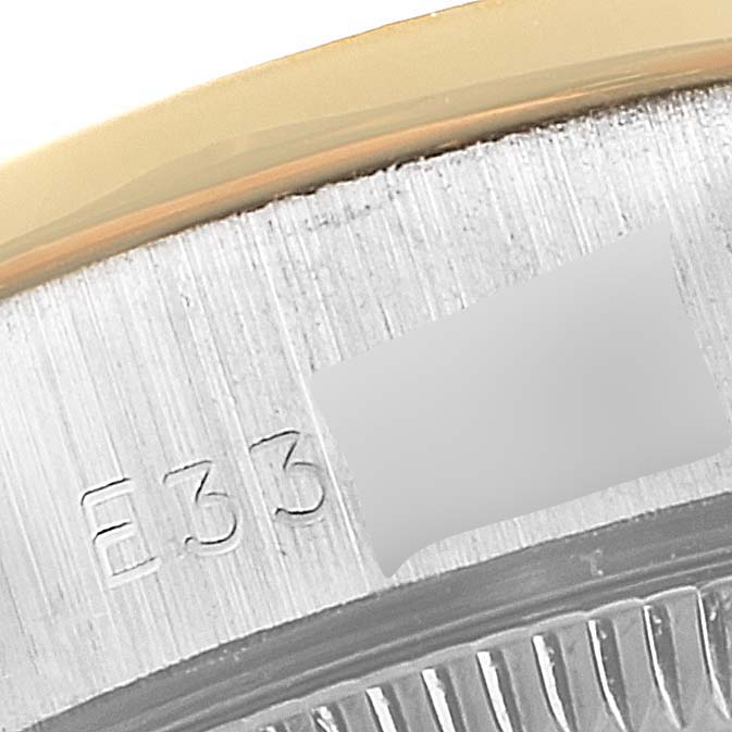 This image shows a close-up of the Rolex President 69139 Women
s White Gold Mother of Pearl Dial 69139 Women
s White Gold Mother of Pearl Dial model with part of the bezel and markings visible.