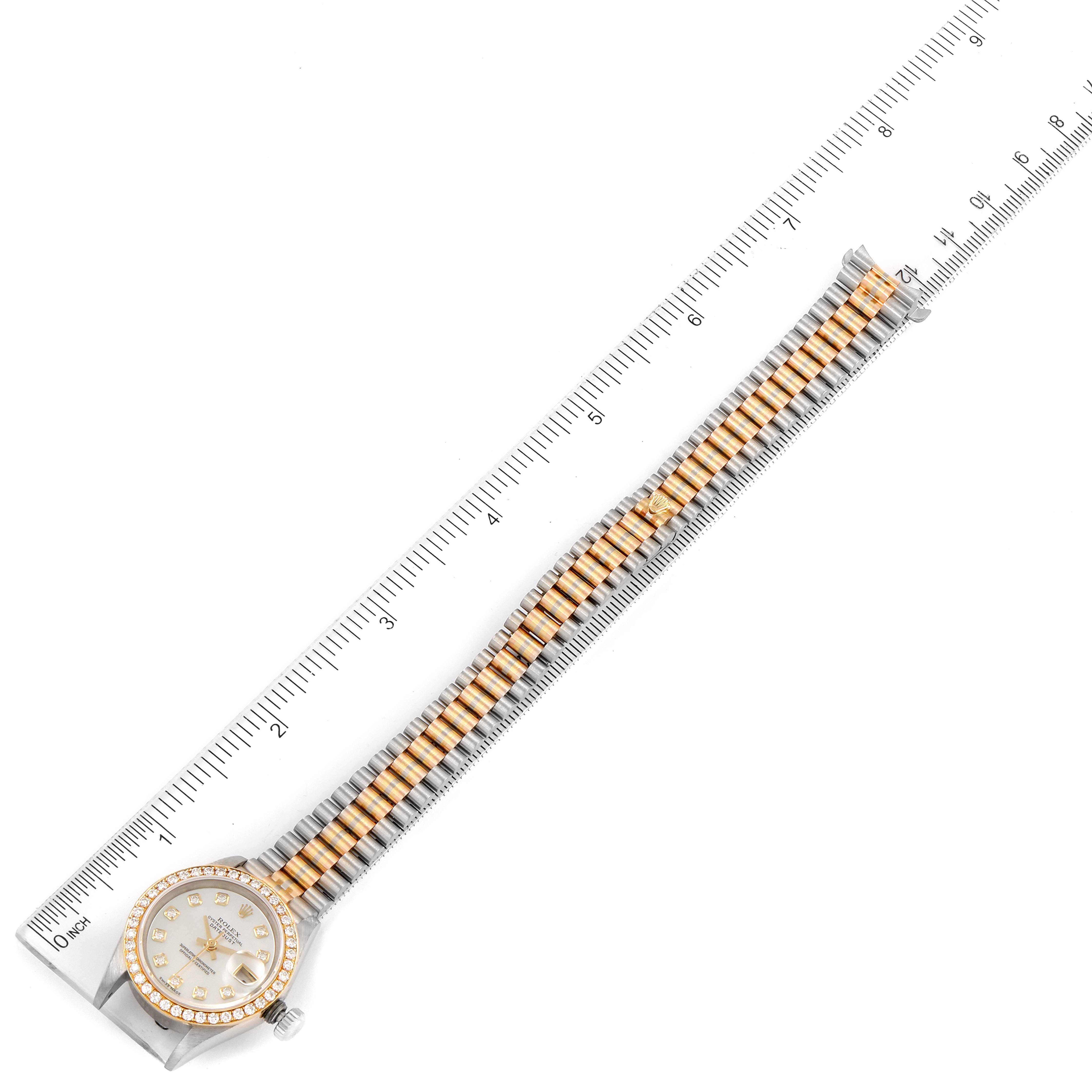 The image shows a Rolex President 69139 Women
s White Gold Mother of Pearl Dial 69139 Women
s White Gold Mother of Pearl Dial model watch laid flat with a ruler measuring its length.