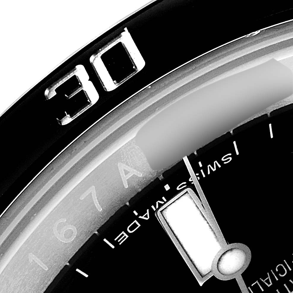 The image shows a close-up of the bezel and part of the dial of a Rolex Submariner 114060 Men
s Stainless Steel Black Dial 114060 Men
s Stainless Steel Black Dial watch, displaying the "30" marker and "Swiss Made" text.