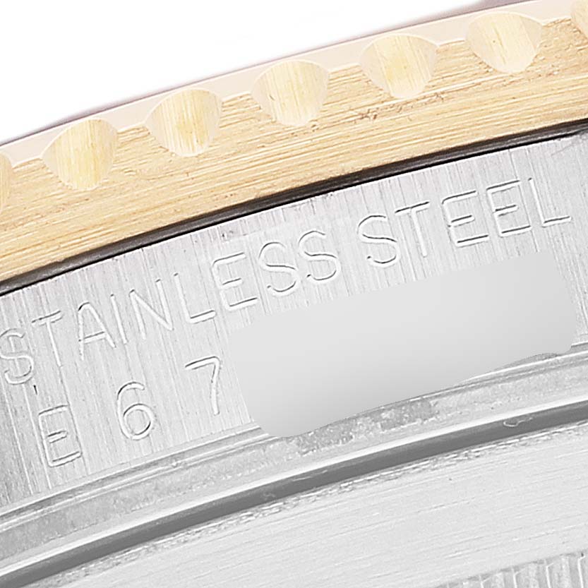 The image shows a close-up of the bezel and engraved inscription on the case back of a Rolex Submariner 16613 Men's Steel and Gold (two tone) Blue Dial 16613 Men's Steel and Gold (two tone) Blue Dial watch.