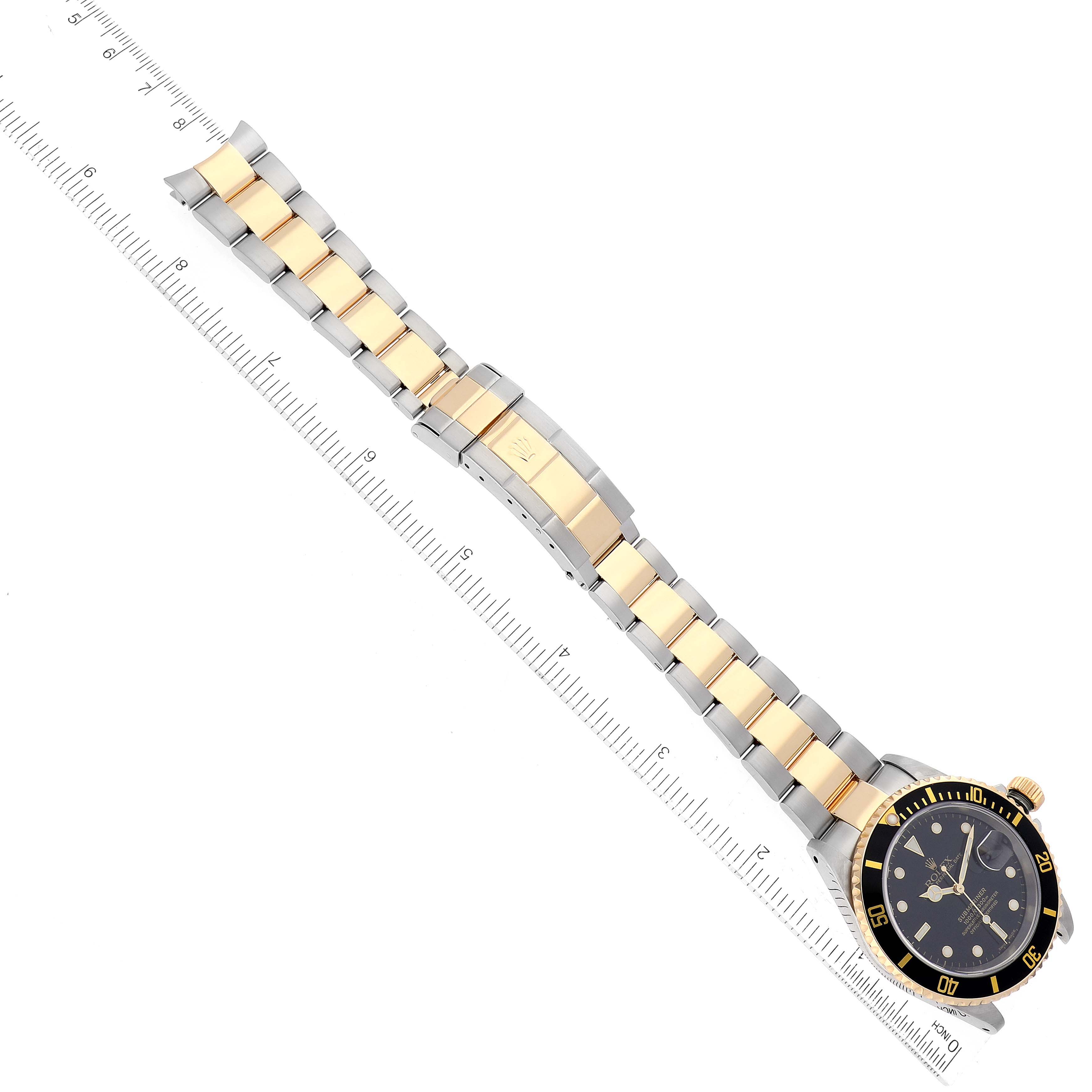 The image shows a top-down view of a Rolex Submariner 16613 Men
s Steel and Gold (two tone) Black Dial 16613 Men
s Steel and Gold (two tone) Black Dial watch, highlighting its black dial, bezel, and two-tone bracelet.