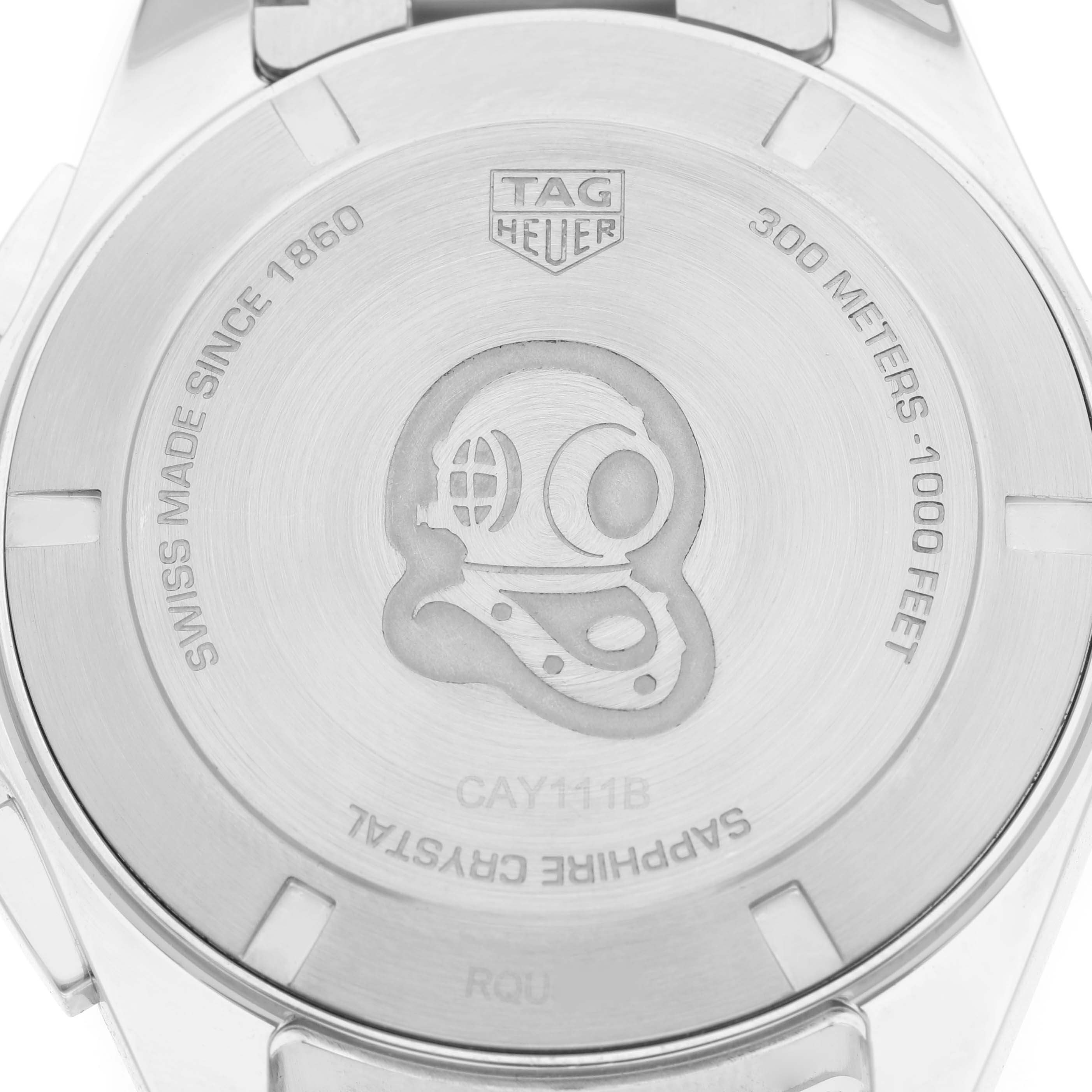 The image shows the back of a Tag Heuer Aquaracer CAY111B.BA0927 Men's Stainless Steel Blue Dial watch, highlighting its inscriptions and emblem.