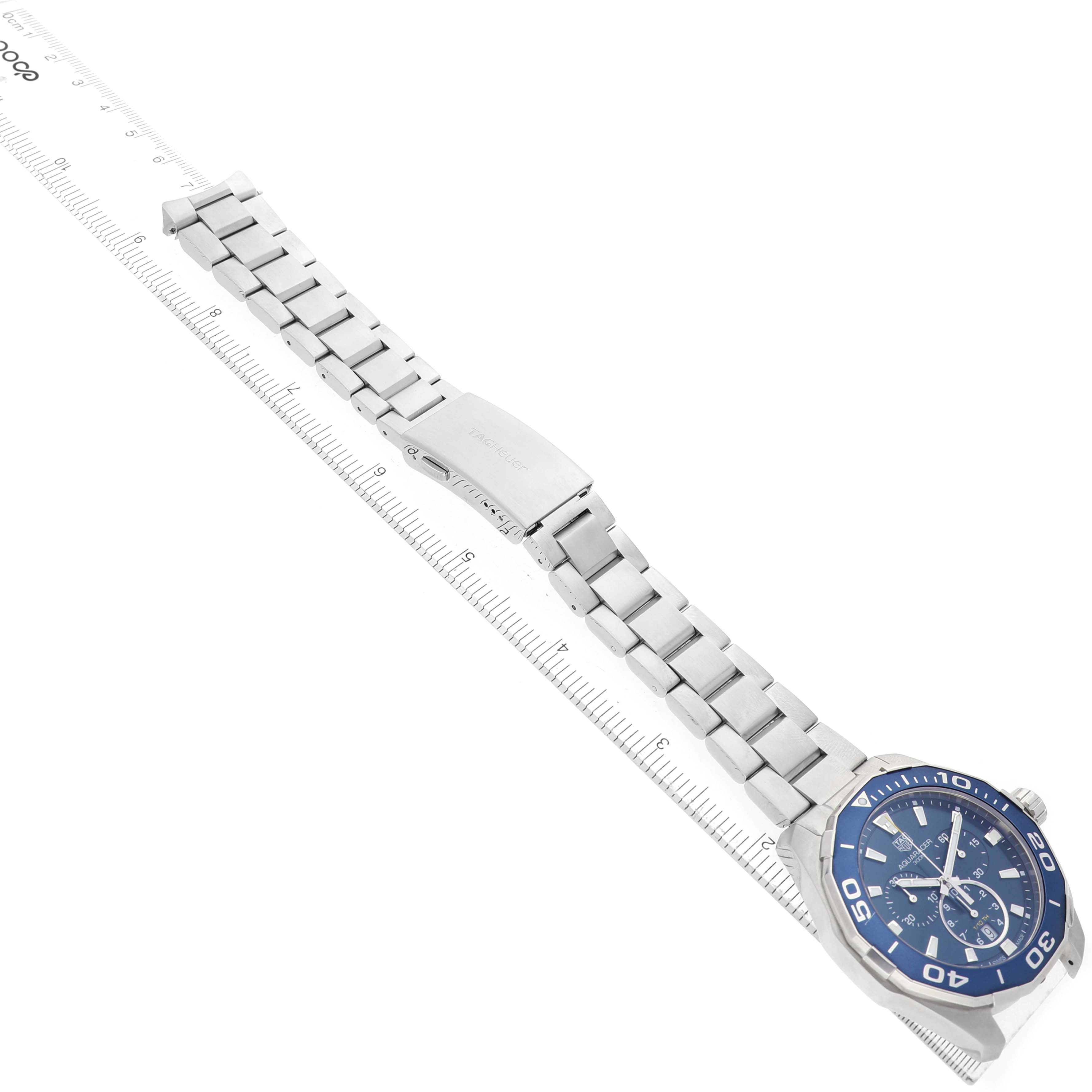 The Tag Heuer Aquaracer CAY111B.BA0927 Men's Stainless Steel Blue Dial watch is shown diagonally with its bracelet extended, displaying the clasp and the blue watch face.