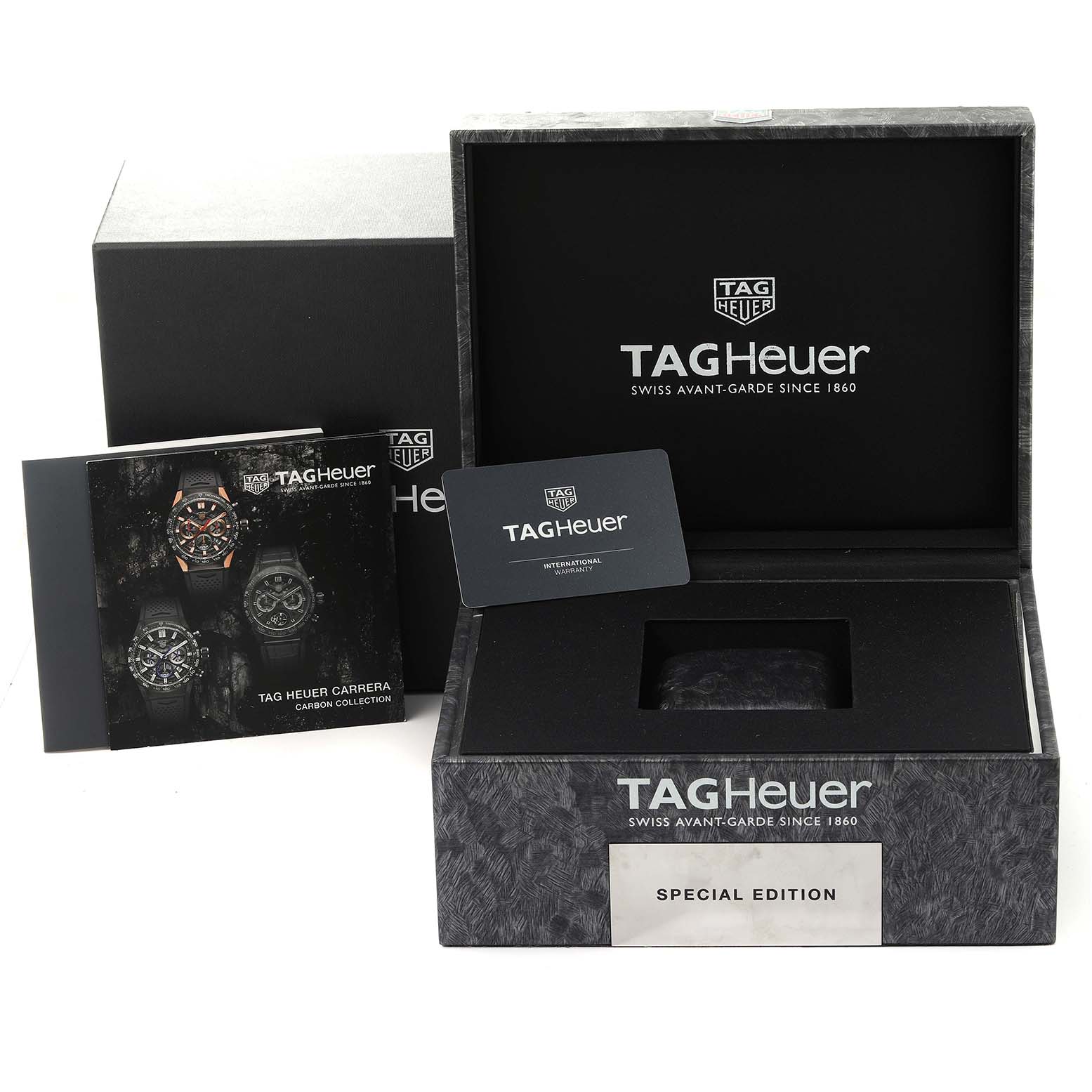 The image shows an open Tag Heuer Carrera watch box, warranty card, and booklet from a front angle.