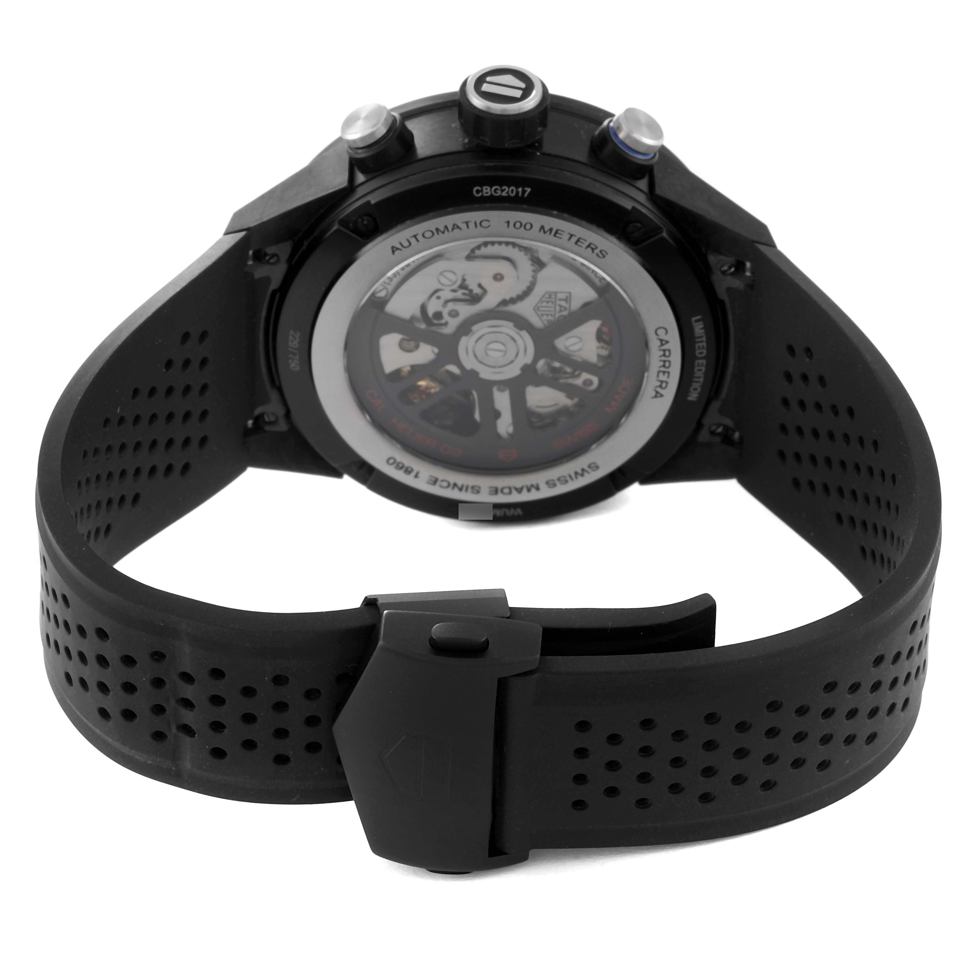 The image shows the back view and strap of a Tag Heuer Carrera watch, displaying its automatic mechanism and buckle.