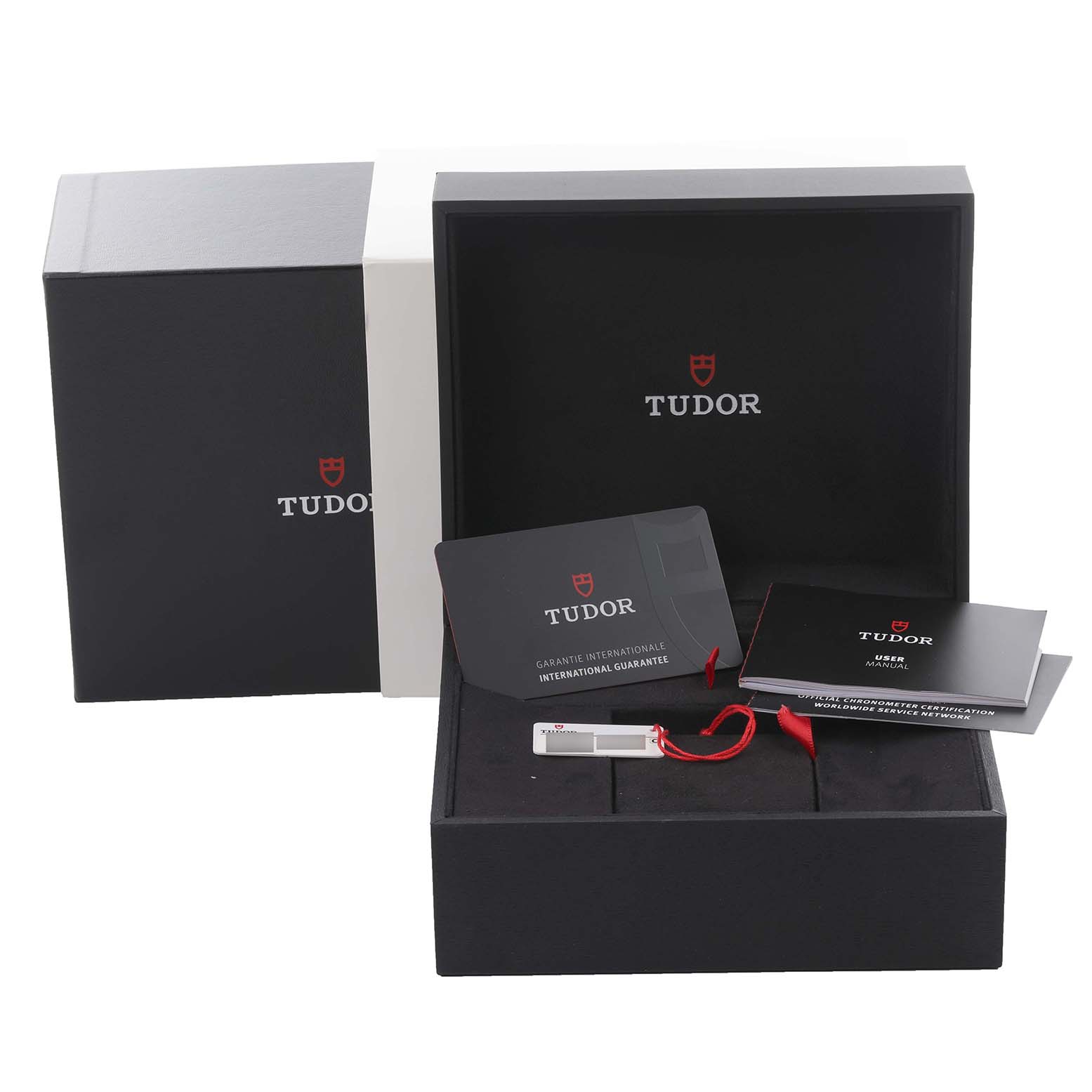The image shows the Tudor Heritage Black Bay M79000N-0001 Men's Stainless Steel Black Dial M79000N-0001 Men's Stainless Steel Black Dial watch packaging and accessories including warranty cards and a booklet from a front angle.