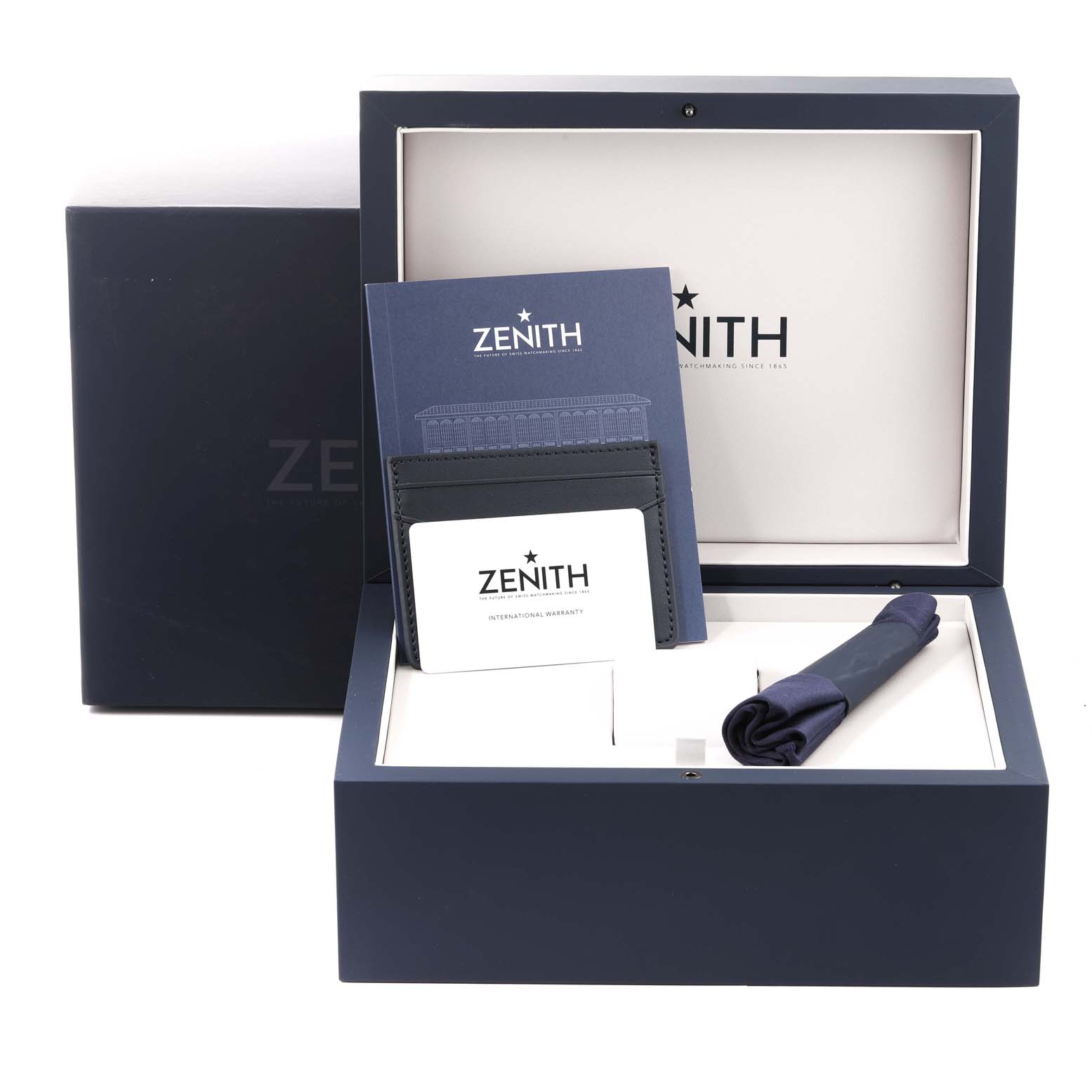 This image shows the accessories of a Zenith Chronomaster 03.3108.3600/57.M3100 Men's Stainless Steel Green Dial 03.3108.3600/57.M3100 Men's Stainless Steel Green Dial watch, including a box, warranty card, booklet, and a cloth.