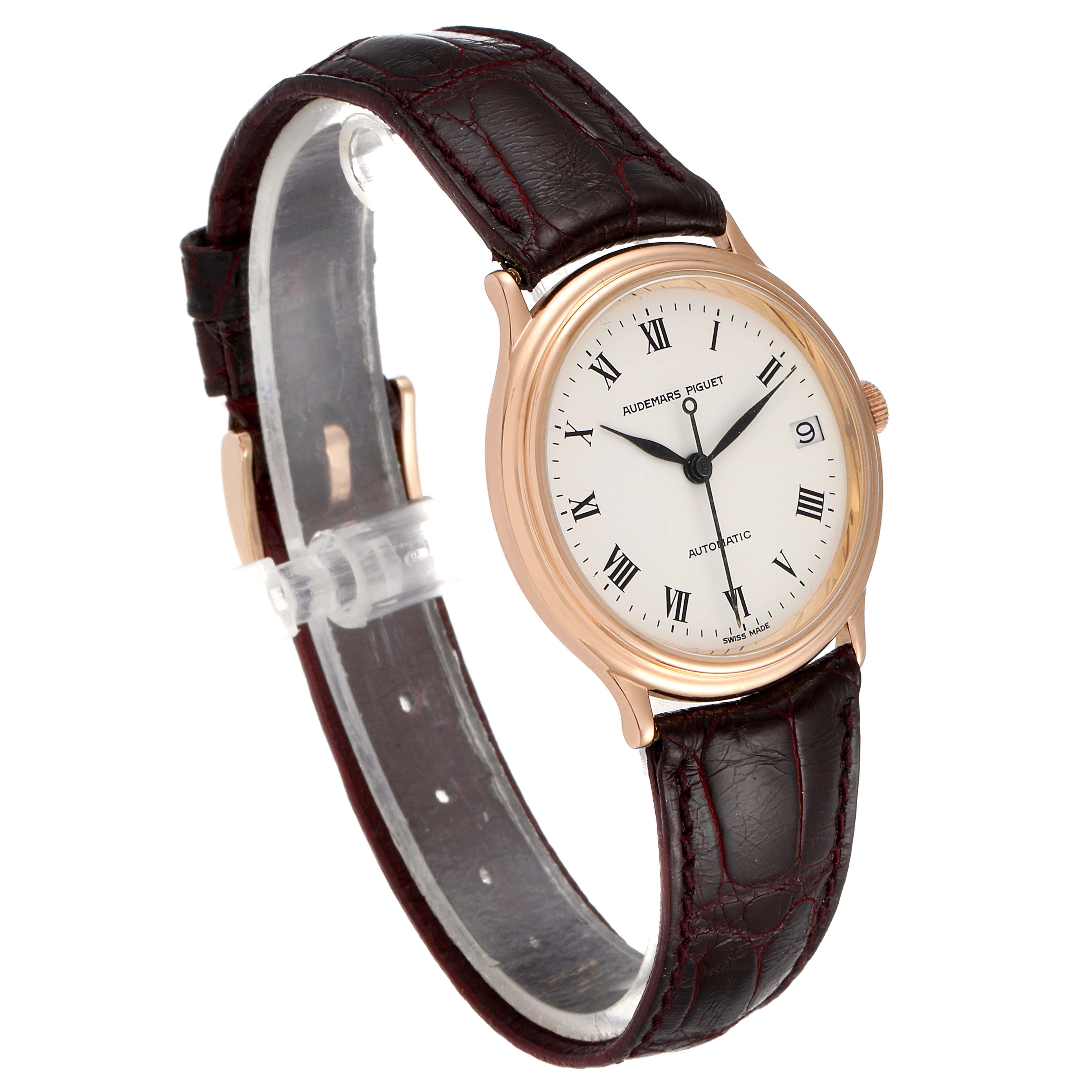 The image shows a Vintage Audemars Piguet watch at an oblique angle, displaying its white dial, Roman numerals, gold case, and leather strap.