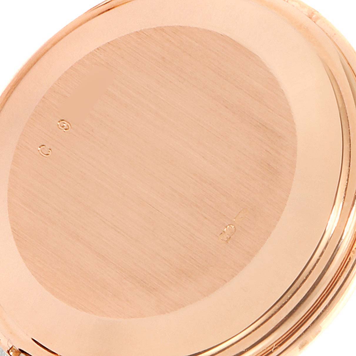 This image shows the back case and part of the edge of a Vintage model watch by Audemars Piguet from a close-up angle.