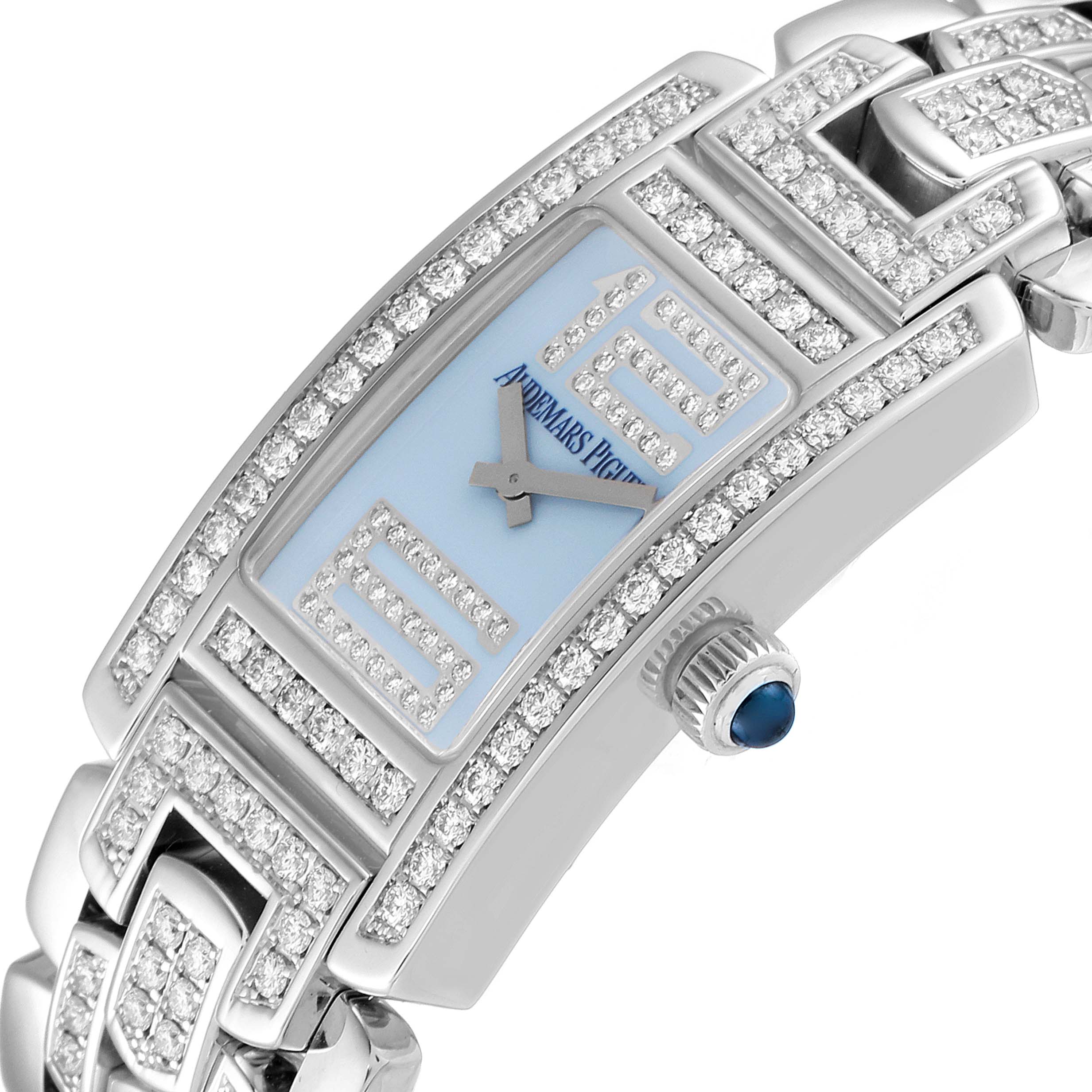 The close-up image shows the face and side of a Vintage Audemars Piguet watch, highlighting its diamond-encrusted bezel and blue crown.