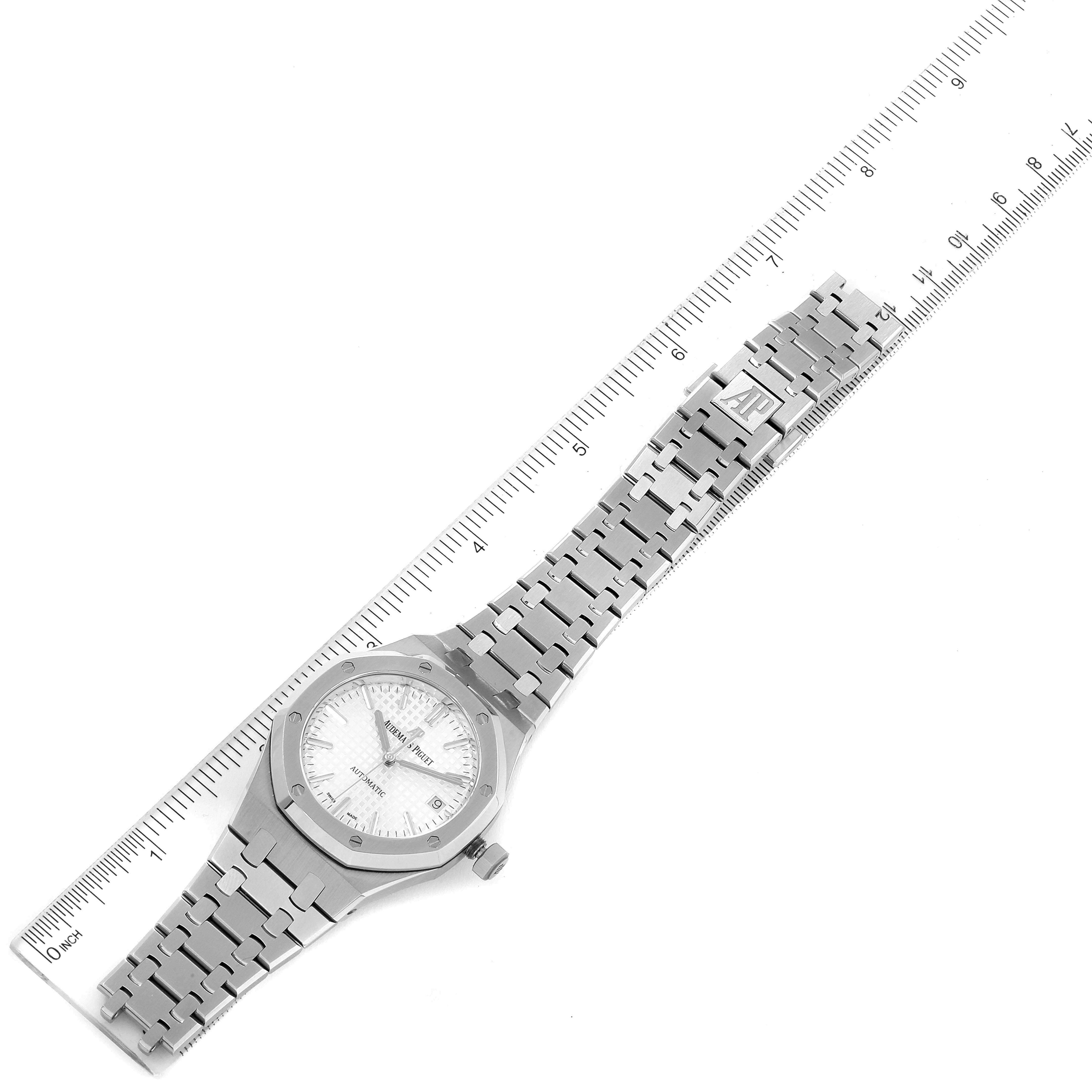 The Audemars Piguet Royal Oak 15450ST.OO.1256ST.01 Men's Stainless Steel Silver Dial 15450ST.OO.1256ST.01 Men's Stainless Steel Silver Dial watch is shown from a top-down angle, displaying the face, bracelet, and clasp alongside a ruler.