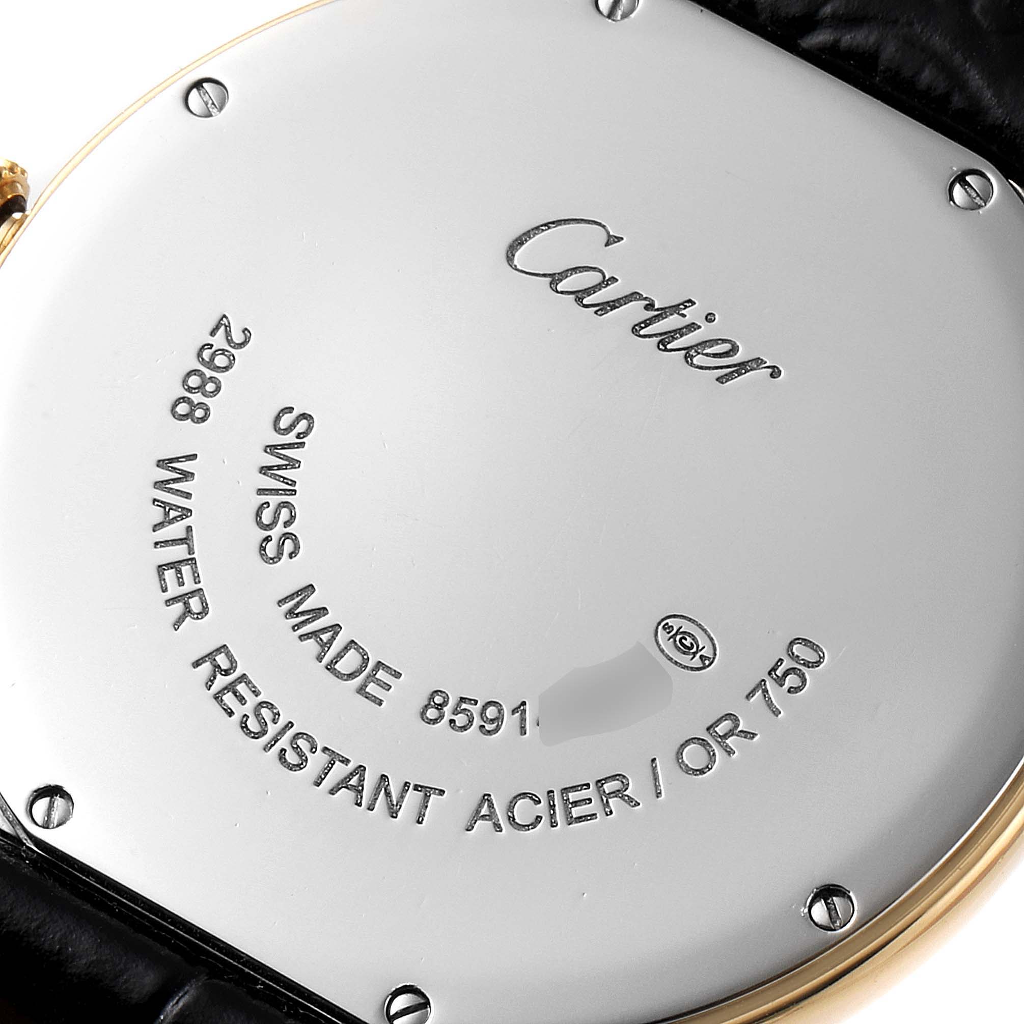 The image shows the back case of the Cartier Ronde W6700455 Men
s Steel and Gold (two tone) Silver Dial W6700455 Men
s Steel and Gold (two tone) Silver Dial watch, displaying engravings and fixation screws.