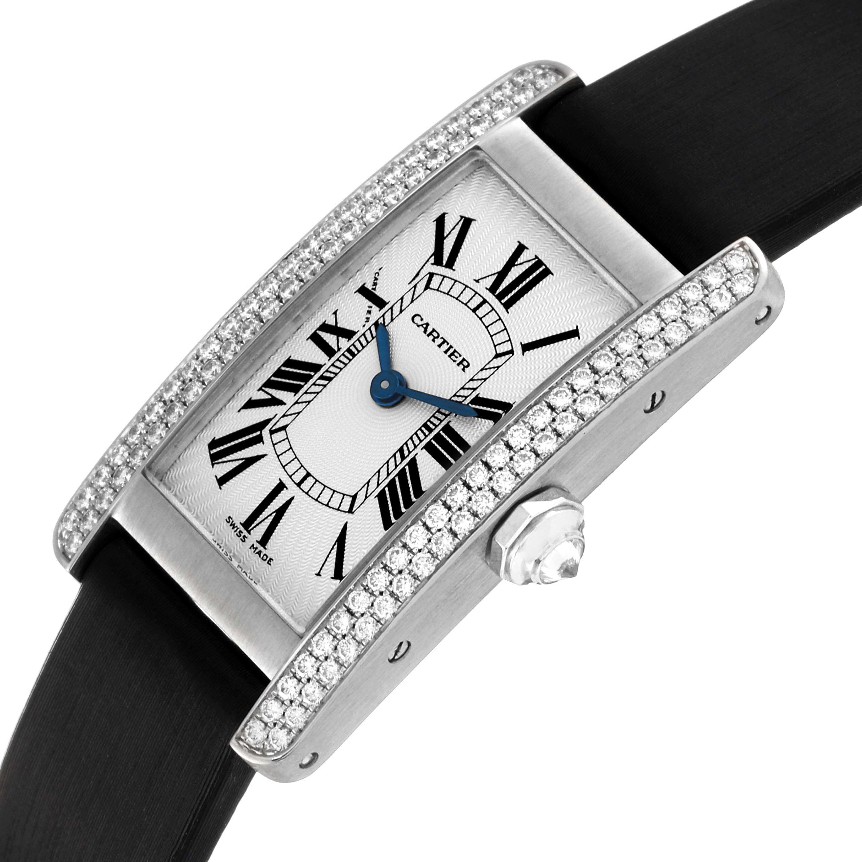 The image shows a Cartier Tank Americaine WB701851 Women's White Gold Silver Dial WB701851 Women's White Gold Silver Dial watch at an angled view, highlighting the face, Roman numerals, blue hands, crown, and diamond-set edges.