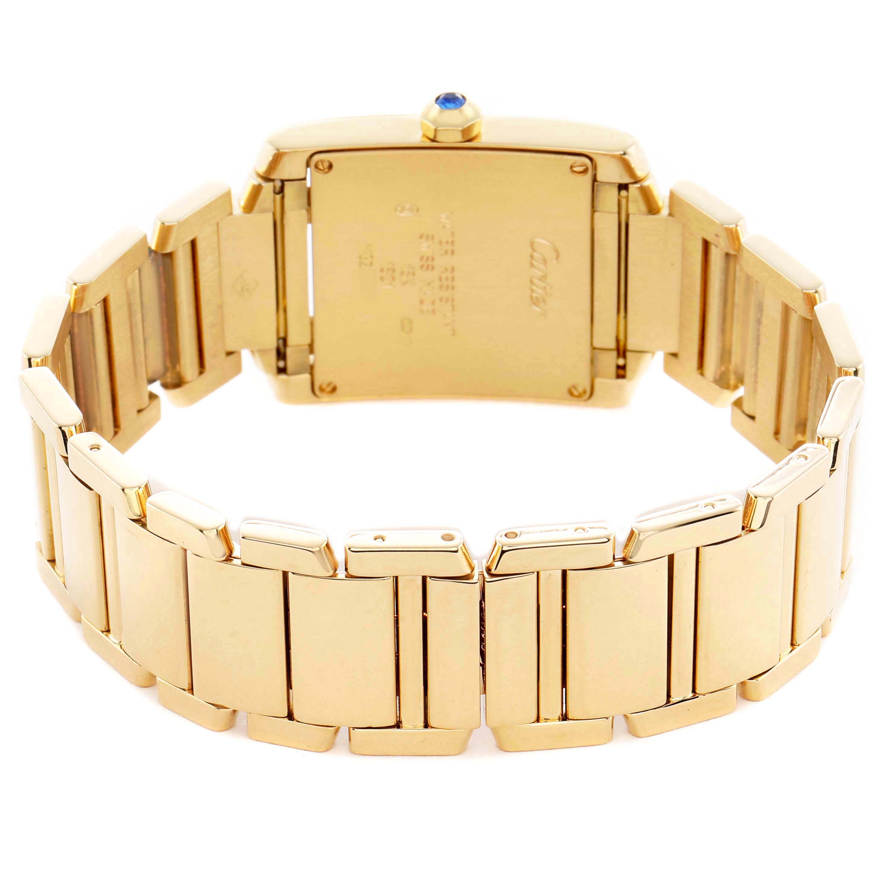 The Cartier Tank Francaise W50003N2 Women's Yellow Gold Silver Dial watch is shown from the back, highlighting the gold bracelet and case back with its markings.