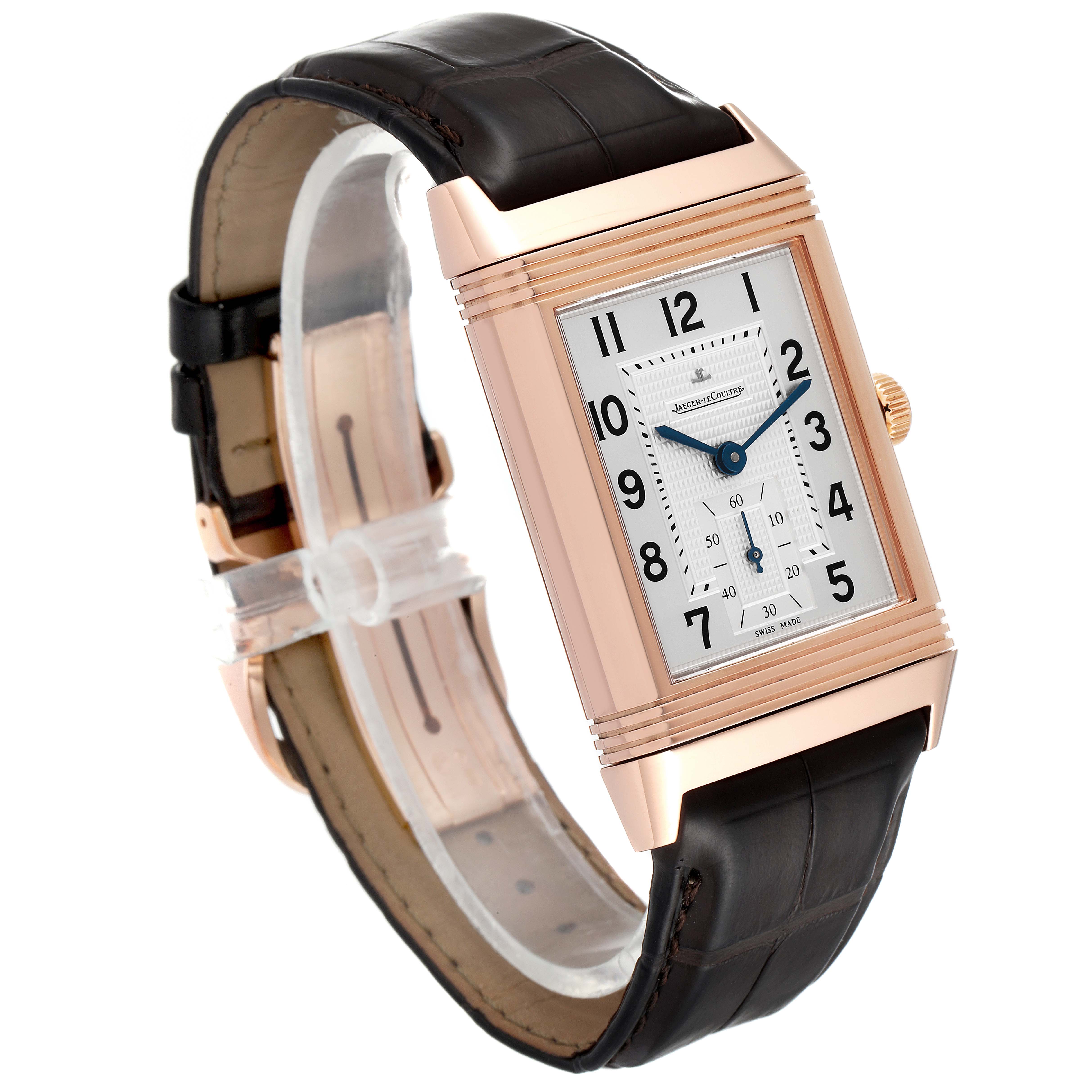 This Jaeger LeCoultre Reverso Q3732420 Men
s Rose Gold Silver Dial Q3732420 Men
s Rose Gold Silver Dial watch is shown at an oblique angle highlighting its rectangular face, gold case, and leather strap.