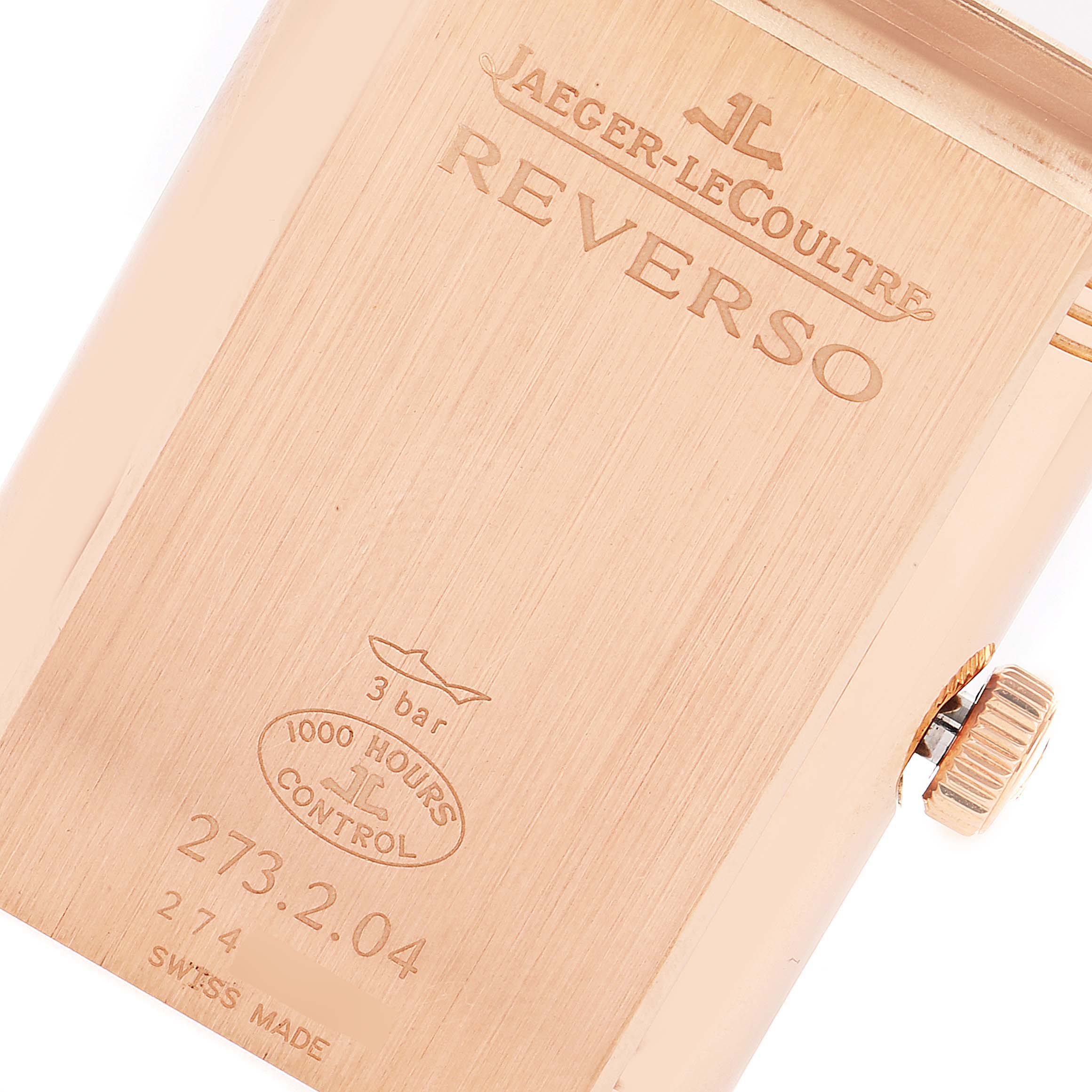 The image shows the case back and crown of a Jaeger-LeCoultre Reverso watch from an angled perspective.