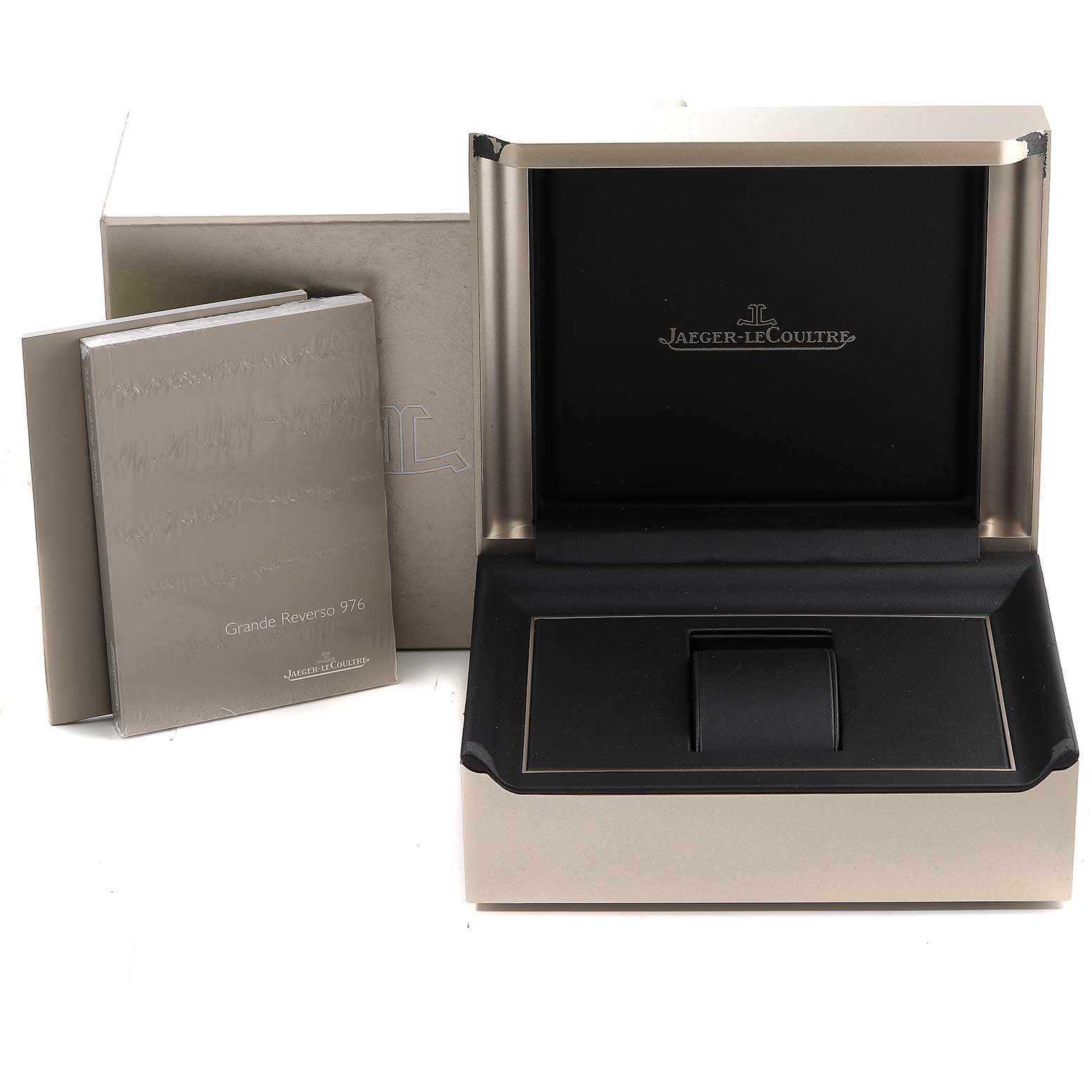 The image shows an open watch box and a manual for the Jaeger-LeCoultre Reverso model.