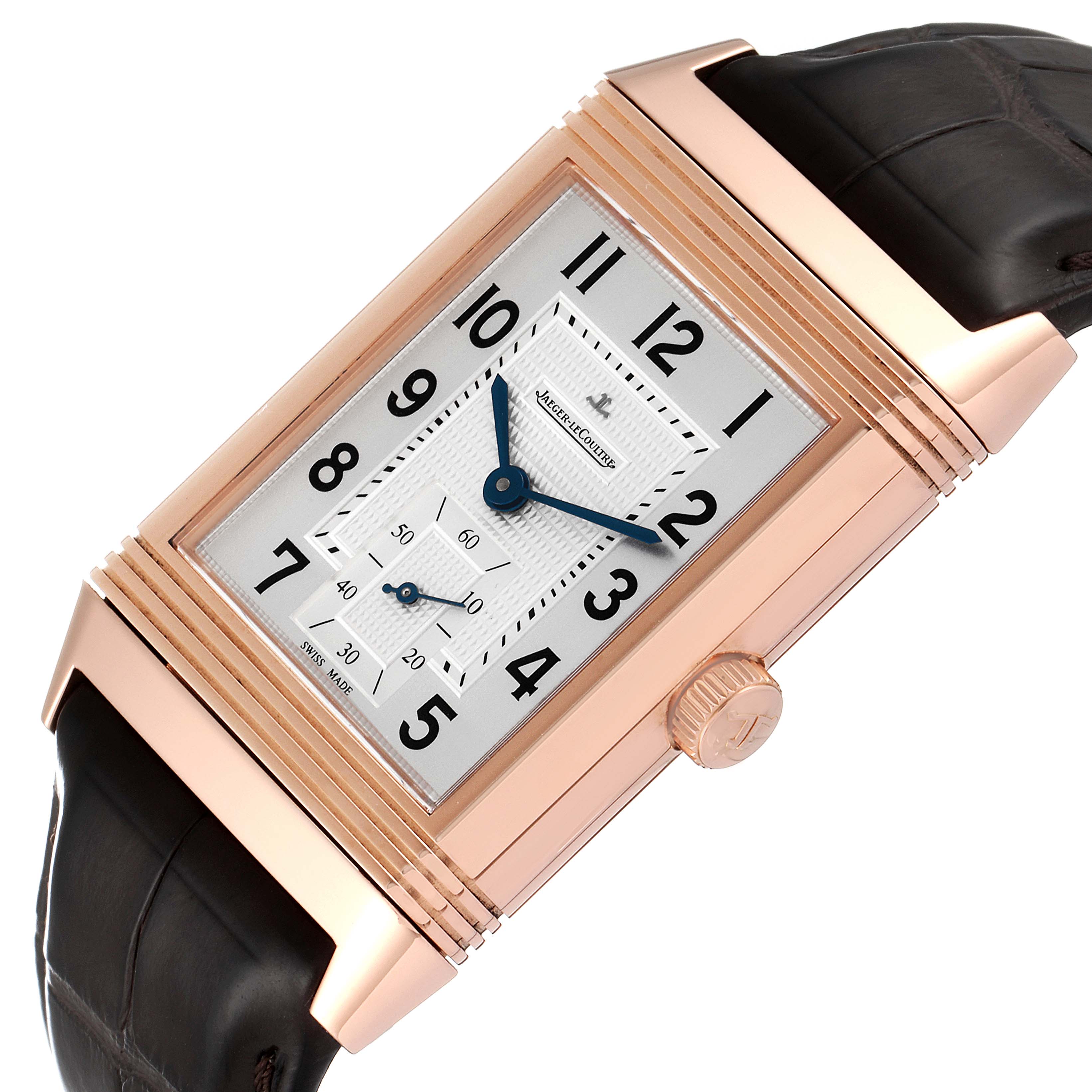 The image shows a Jaeger LeCoultre Reverso Q3732420 Men
s Rose Gold Silver Dial Q3732420 Men
s Rose Gold Silver Dial watch, highlighting its rectangular dial, crown, and leather strap at an angled view.