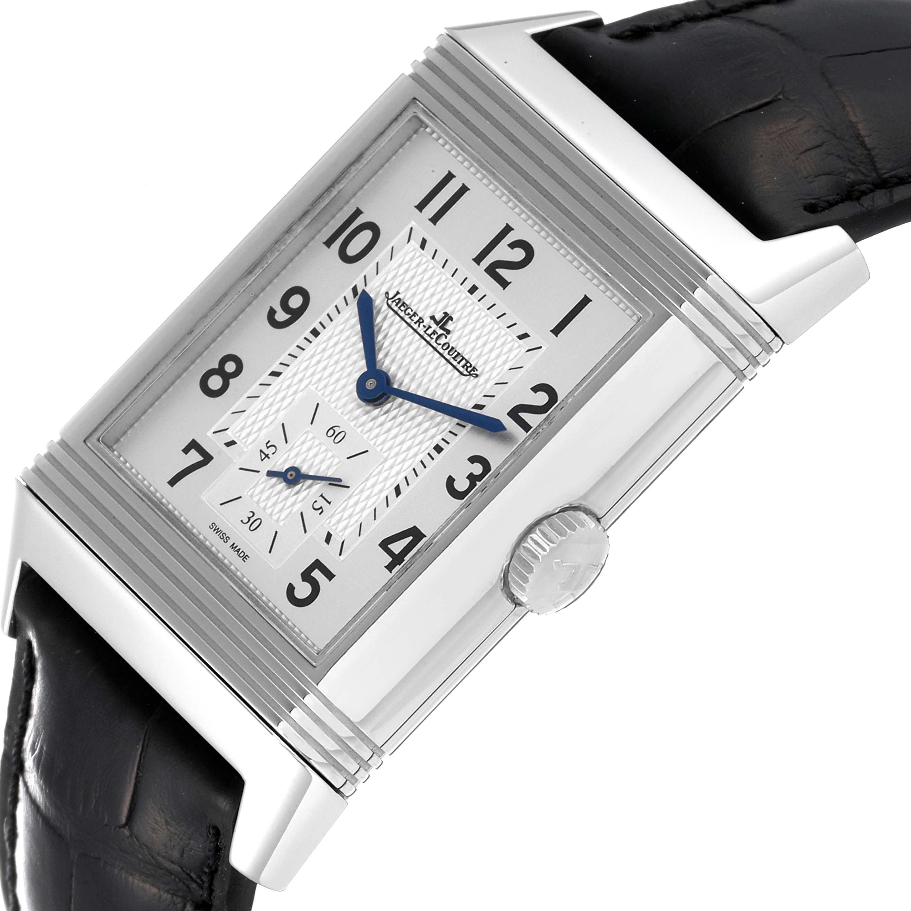 The image shows a close-up of a Jaeger LeCoultre Reverso Q3848420 Men's Stainless Steel Silver Dial Q3848420 Men's Stainless Steel Silver Dial watch, highlighting the face, crown, and part of the leather strap.