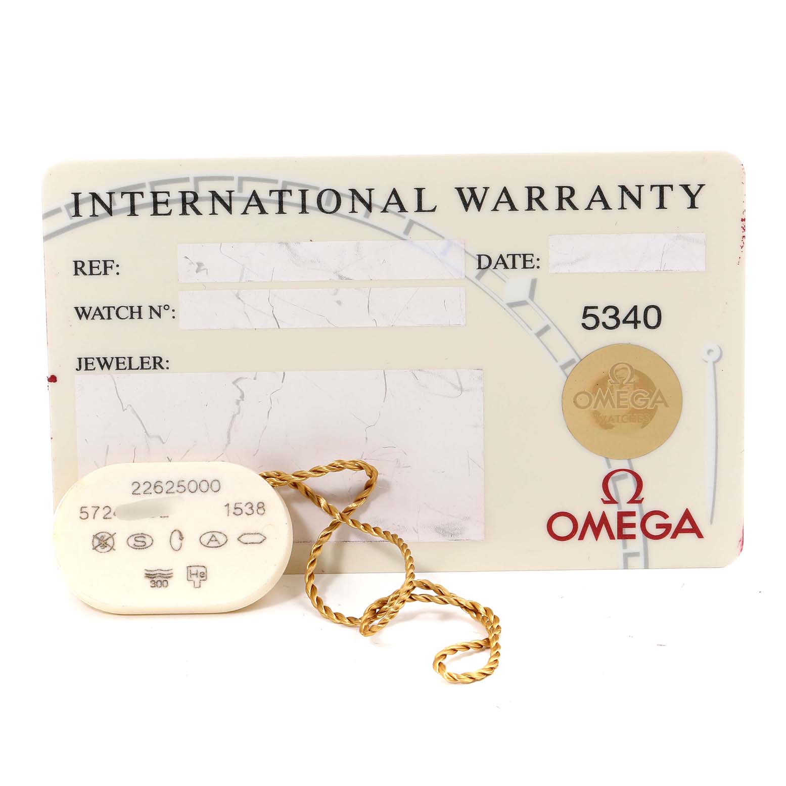 The image shows an Omega Seamaster 2262.50.00 Men
s Stainless Steel Black Dial 2262.50.00 Men
s Stainless Steel Black Dial International Warranty card and a tag with a gold string attached.