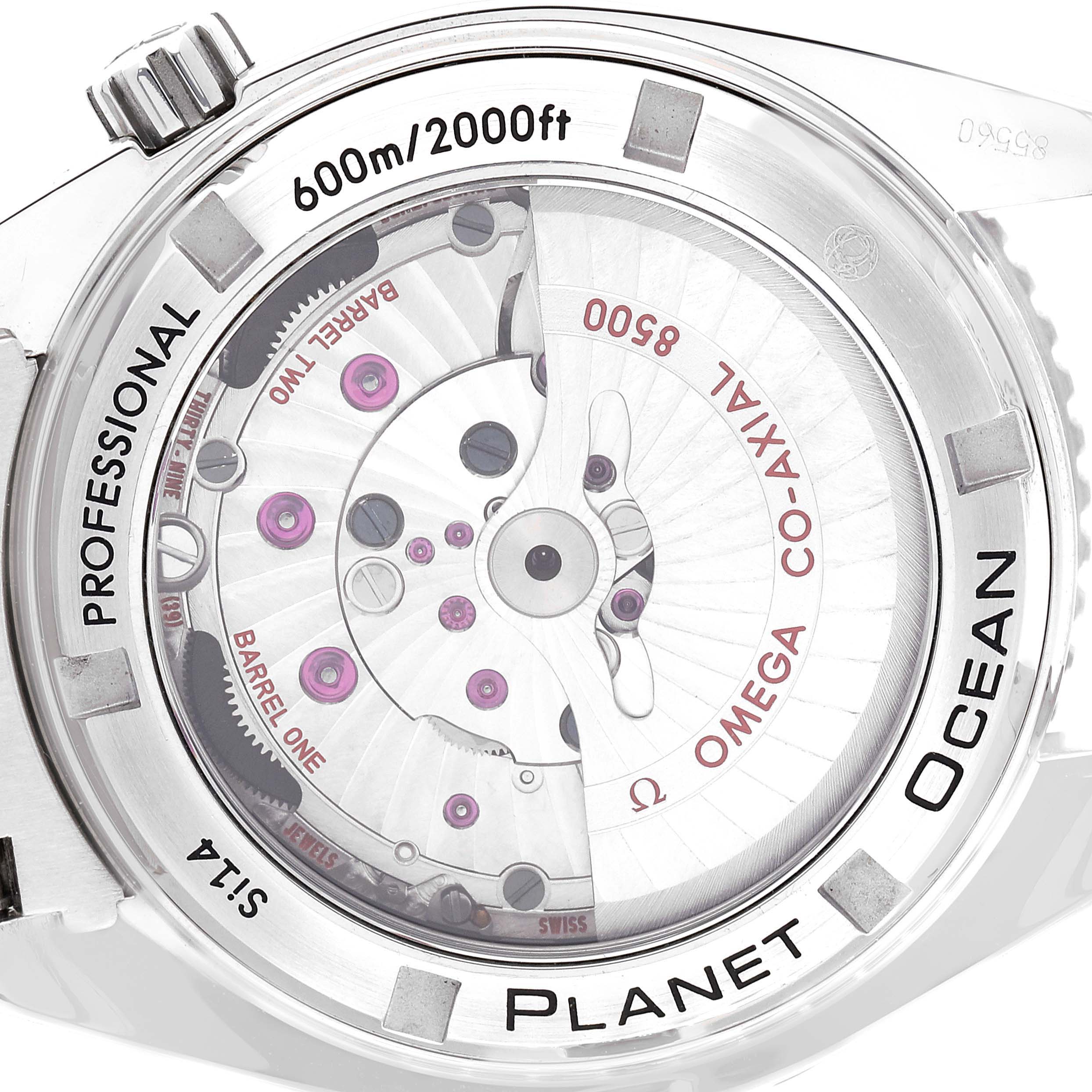 The image shows the back of the Omega Planet Ocean 232.30.42.21.04.001 Men
s Stainless Steel White Dial 232.30.42.21.04.001 Men
s Stainless Steel White Dial watch, highlighting its internal mechanical components and engravings.