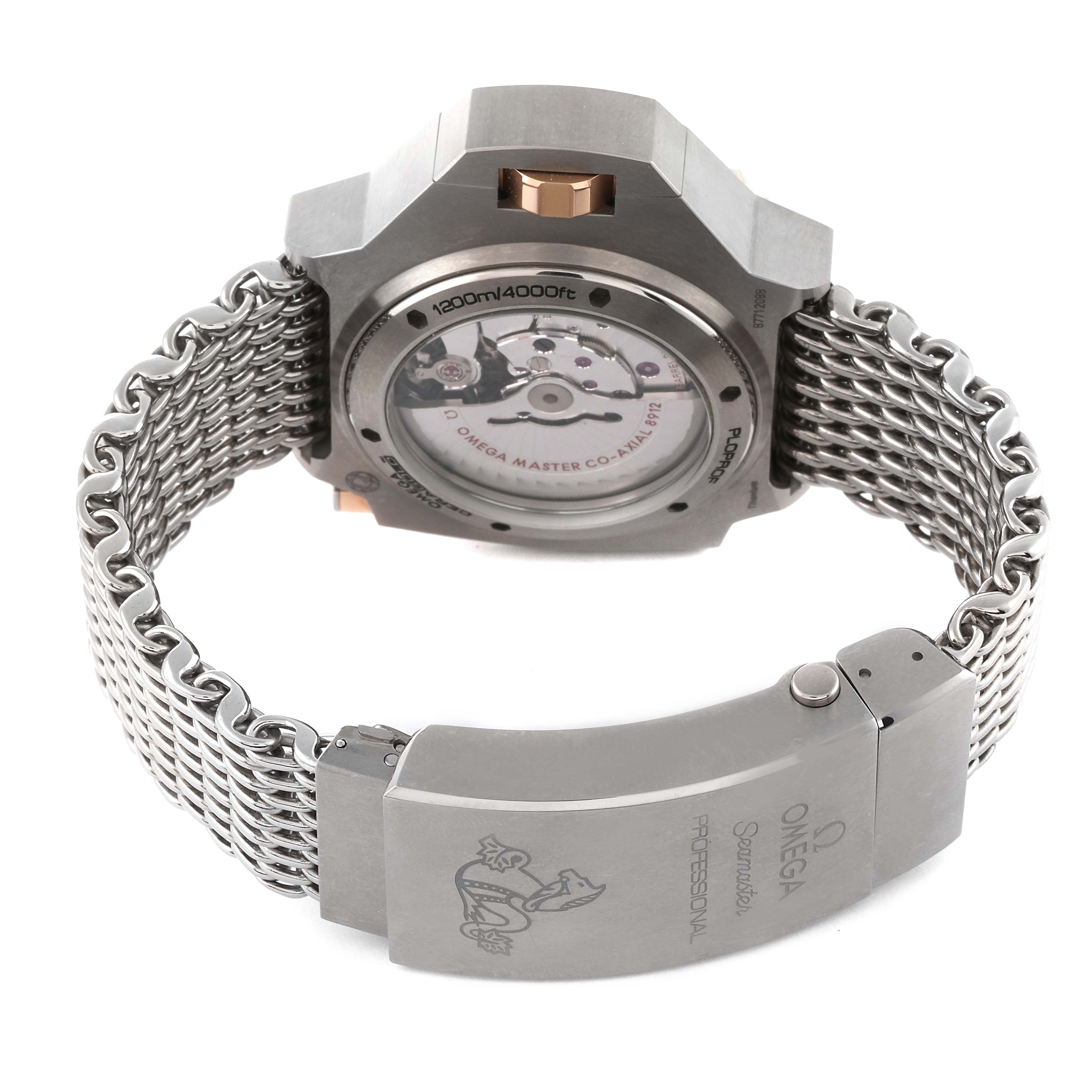 The image shows the back view of an Omega Ploprof 227.60.55.21.03.001 Men's Titanium Blue Dial 227.60.55.21.03.001 Men's Titanium Blue Dial watch, highlighting its mechanism and stainless steel mesh bracelet with clasp.