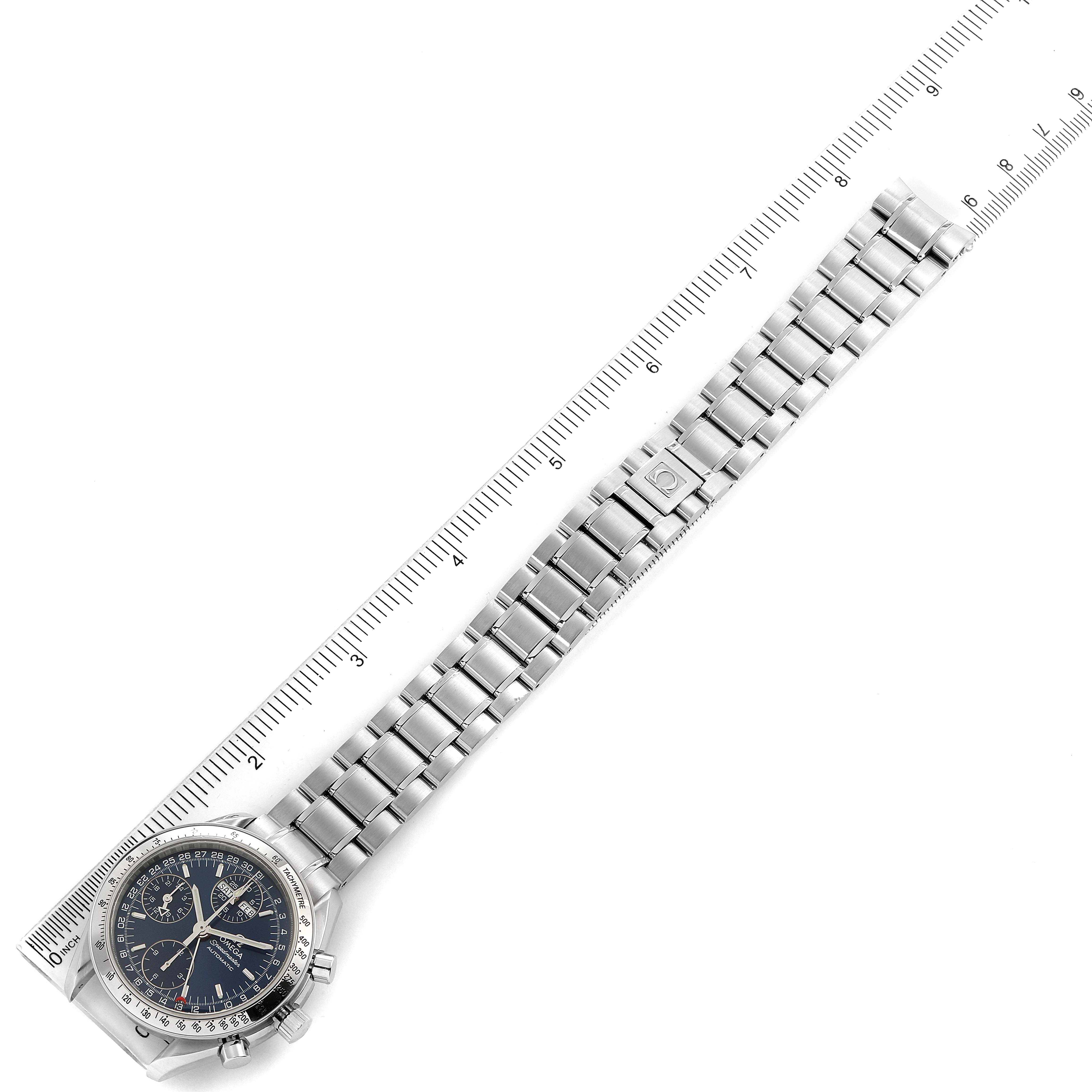 The image shows an Omega Speedmaster 3523.80.00 Men
s Stainless Steel Blue Dial 3523.80.00 Men
s Stainless Steel Blue Dial watch laid flat with its metallic bracelet and clasp visible, next to a ruler for scale.