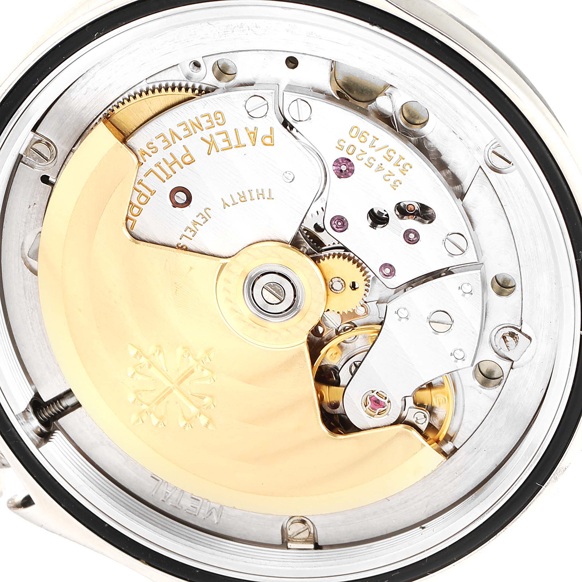 This image shows the movement of a Patek Philippe Calatrava 5107G Men
s White Gold Silver Dial 5107G Men
s White Gold Silver Dial watch, highlighting its intricate inner mechanics and engravings.