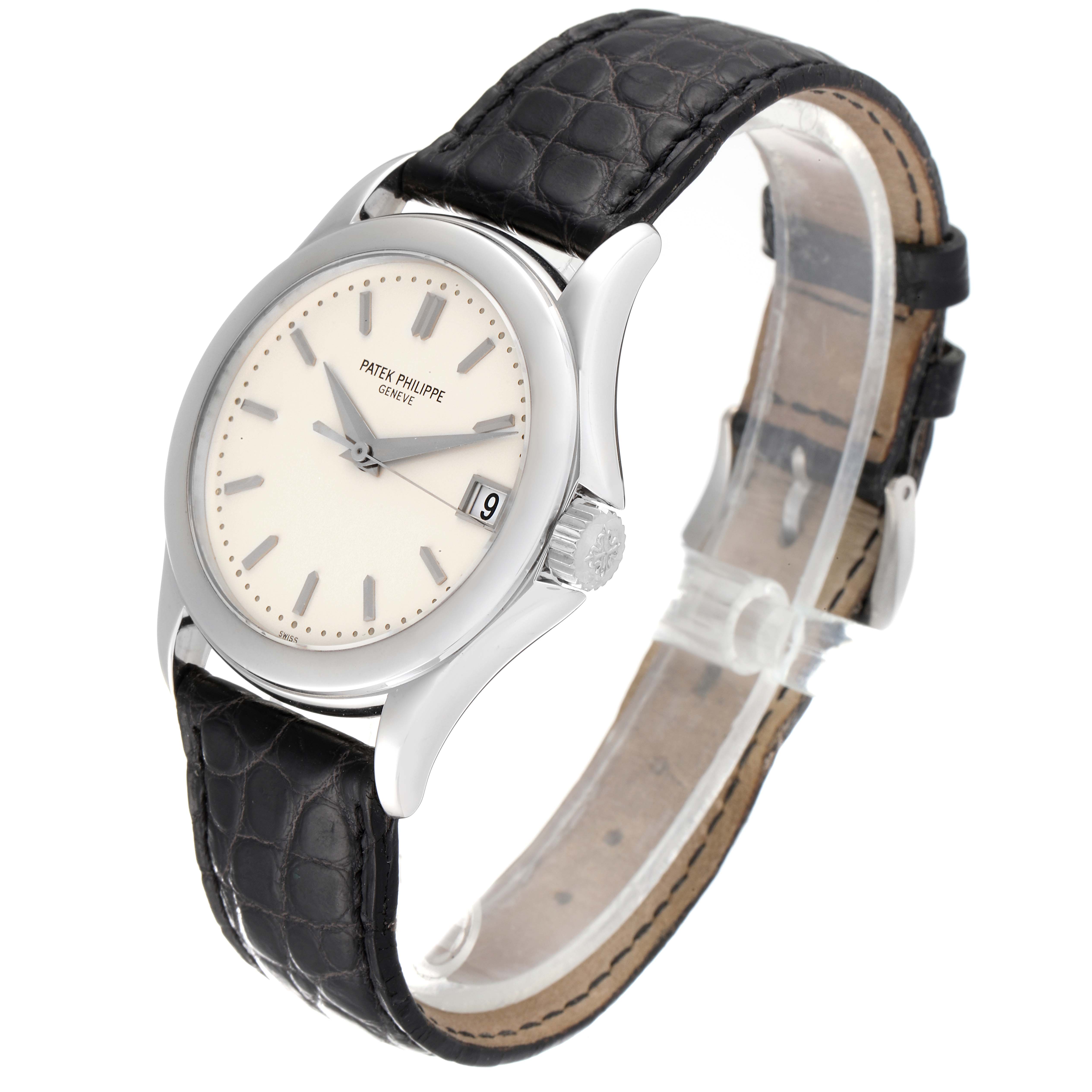 The image shows a side angle view of a Patek Philippe Calatrava 5107G Men
s White Gold Silver Dial 5107G Men
s White Gold Silver Dial watch with a black leather strap and a white dial.