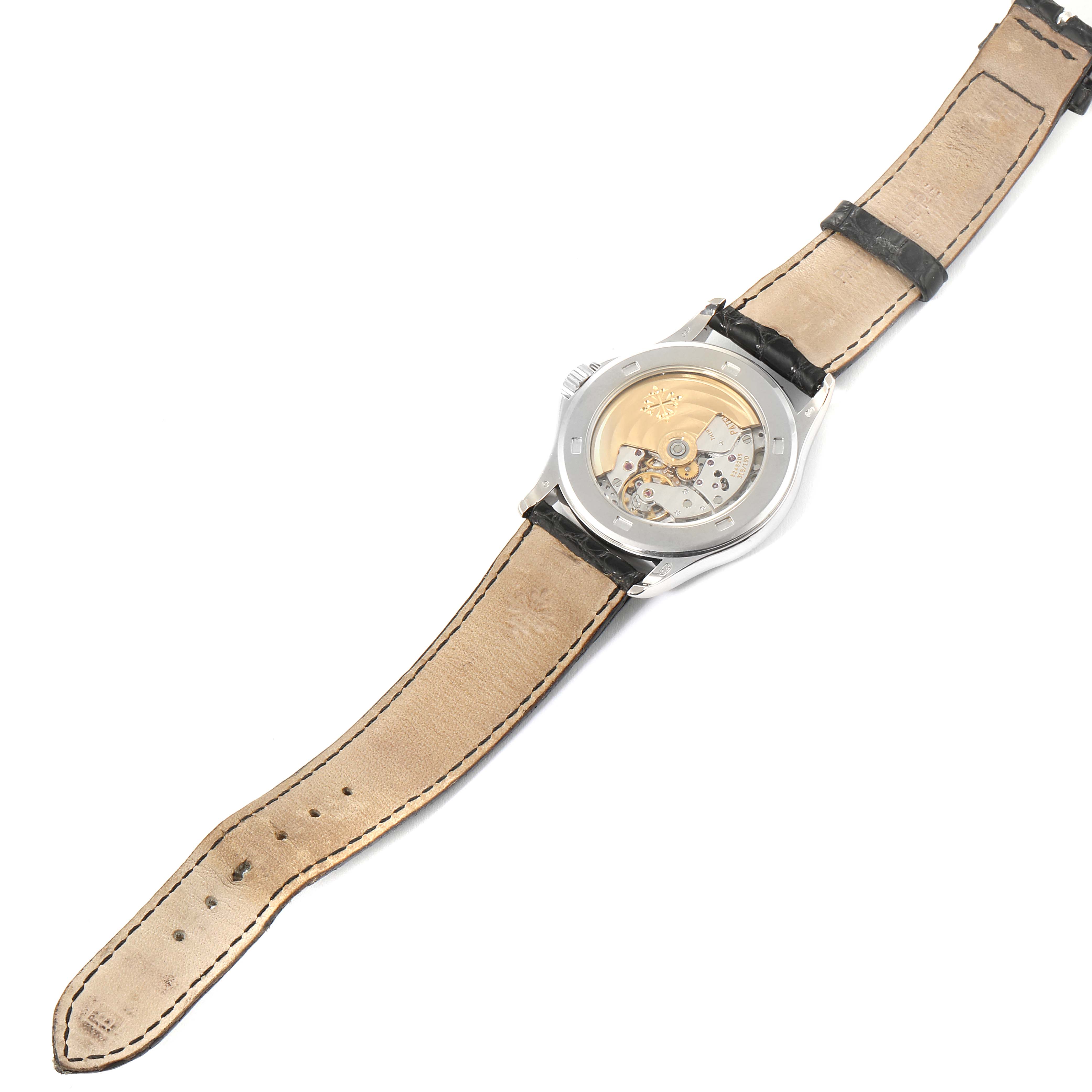 The image shows the back view of a Patek Philippe Calatrava 5107G Men
s White Gold Silver Dial 5107G Men
s White Gold Silver Dial watch, highlighting its transparent case back and visible mechanical movement.