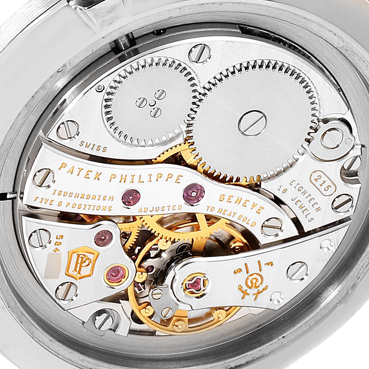 The image shows the intricate inner workings of a Patek Philippe Calatrava 7119G Women's White Gold White Dial 7119G Women's White Gold White Dial watch viewed from the back, highlighting gears and engravings.