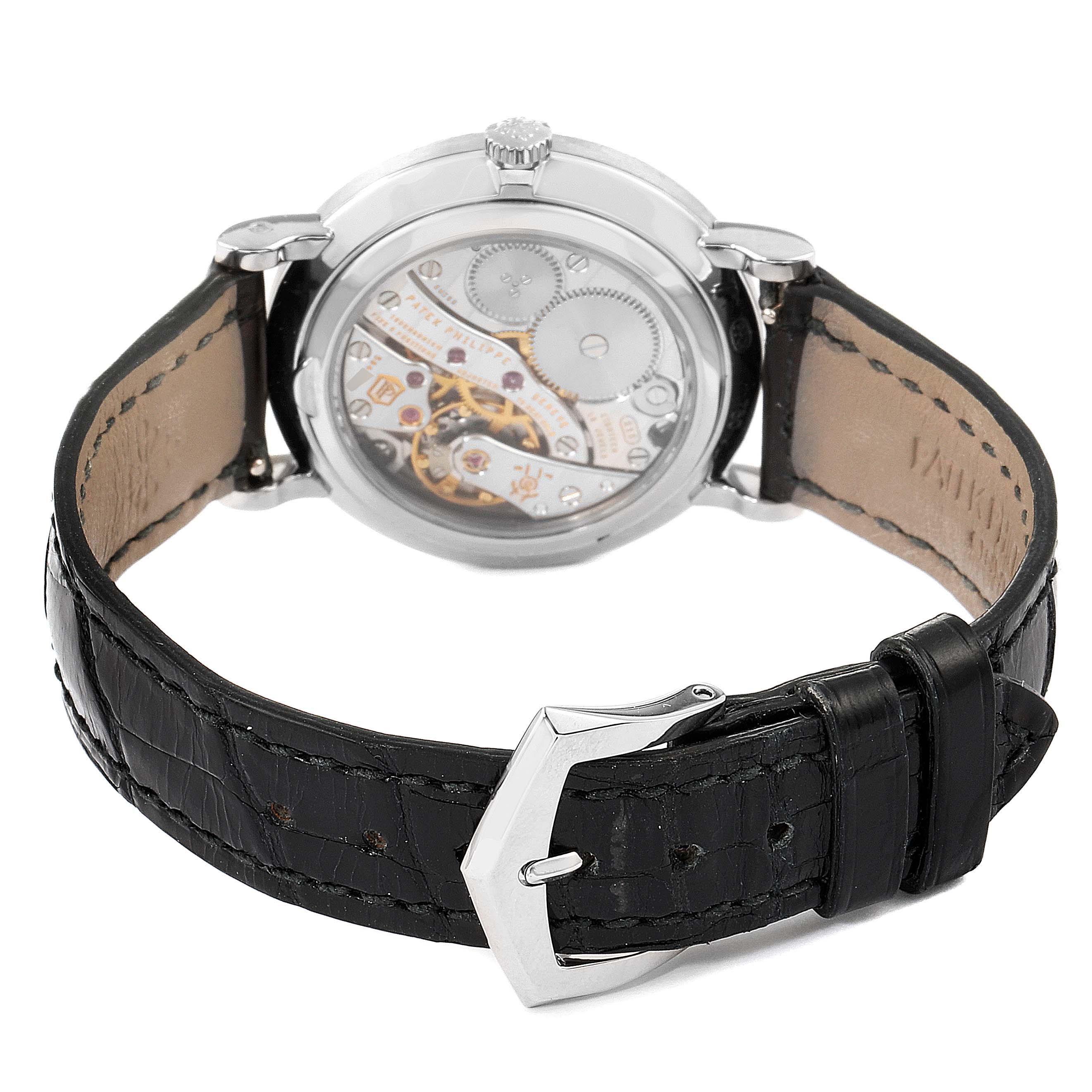 The image shows the back side of a Patek Philippe Calatrava 7119G Women's White Gold White Dial 7119G Women's White Gold White Dial watch, highlighting the mechanical movement and the leather strap.