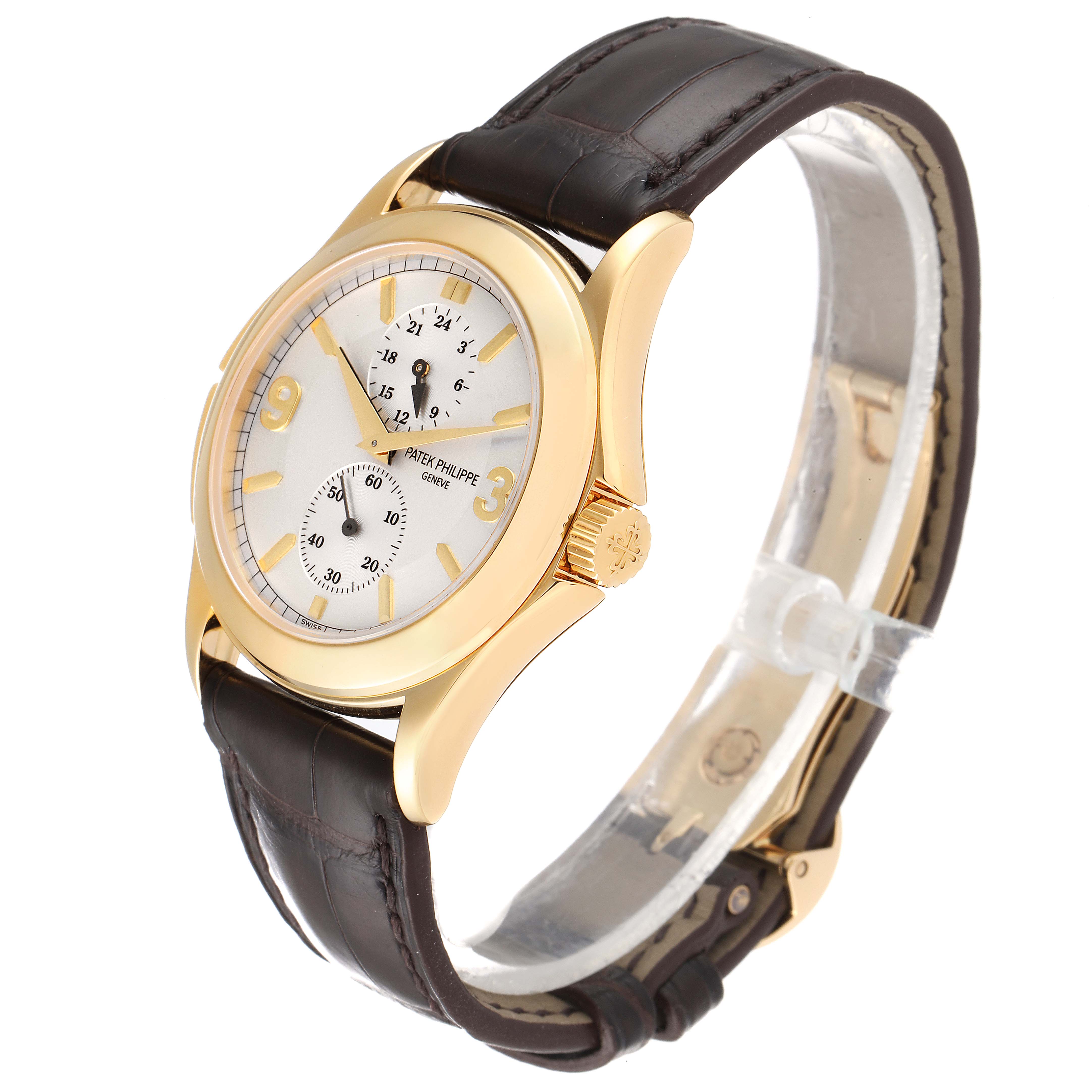 The image shows a Patek Philippe Calatrava 5134J Men
s Yellow Gold White Dial 5134J Men
s Yellow Gold White Dial watch at a three-quarter angle, highlighting its gold case and brown leather strap.