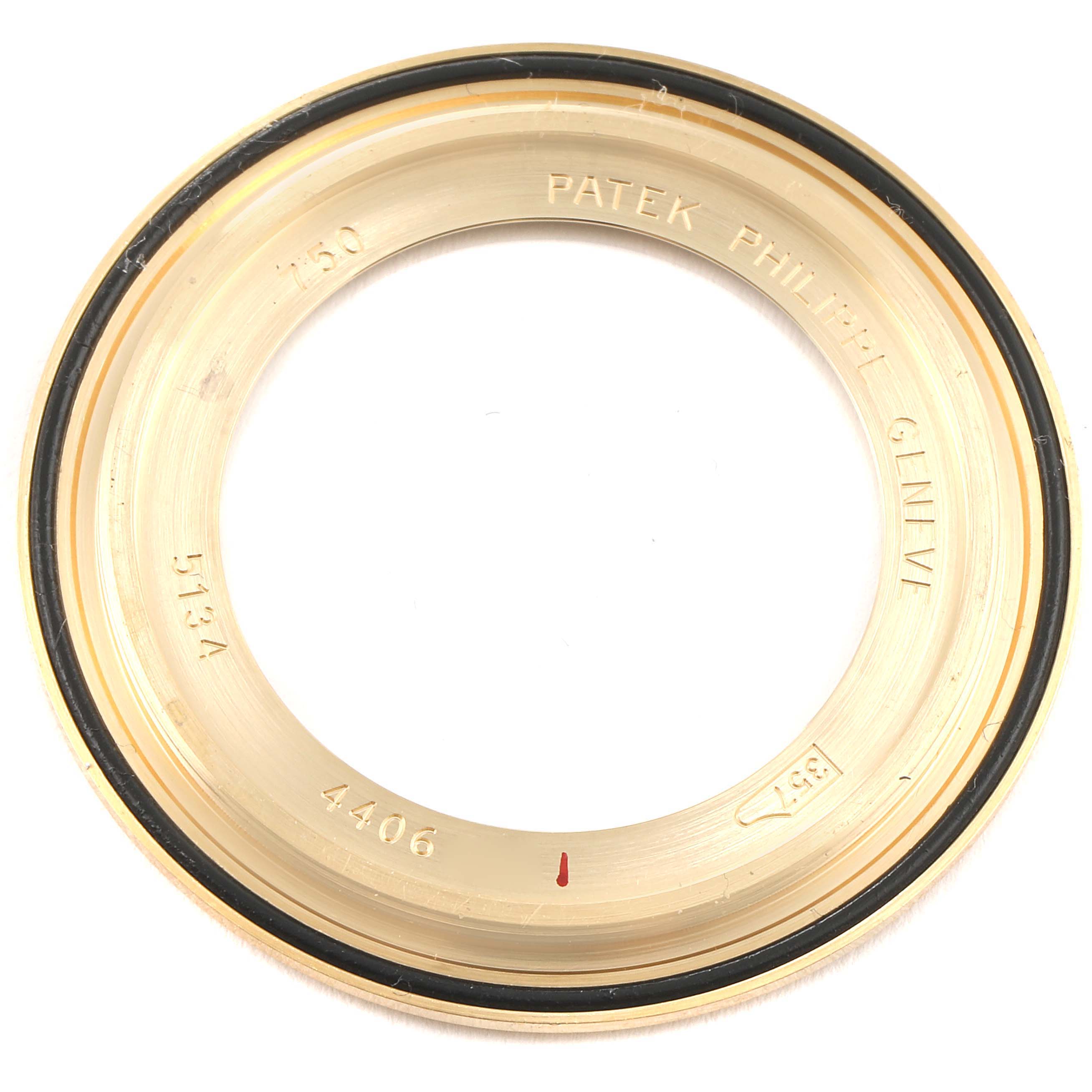 This image shows the gold bezel of a Patek Philippe Calatrava 5134J Men
s Yellow Gold White Dial 5134J Men
s Yellow Gold White Dial model watch from a top-down angle.