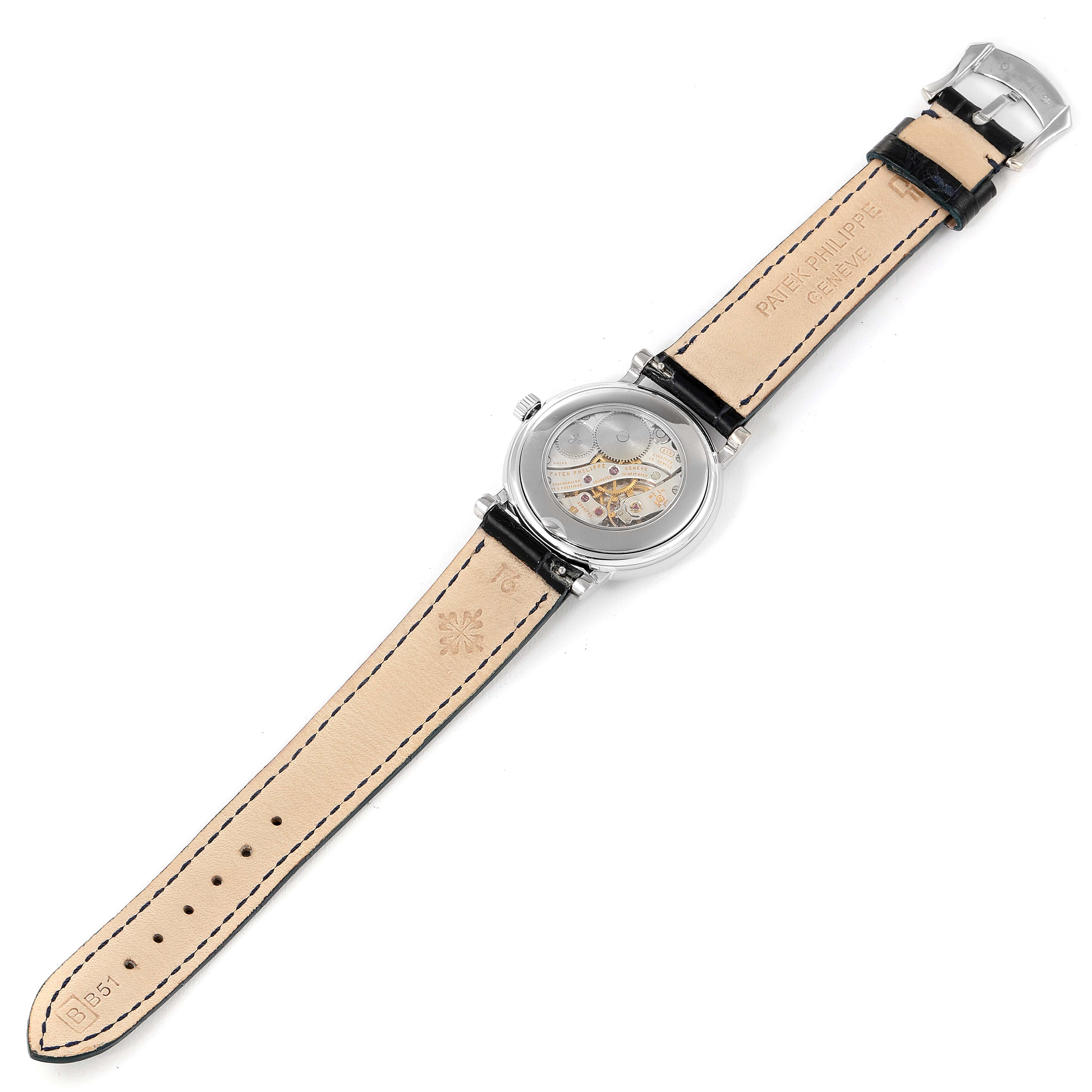 The image shows the reverse side of a Patek Philippe Calatrava 4959G Women's White Gold Mother of Pearl Dial 4959G Women's White Gold Mother of Pearl Dial watch, including the strap, buckle, and watch case.