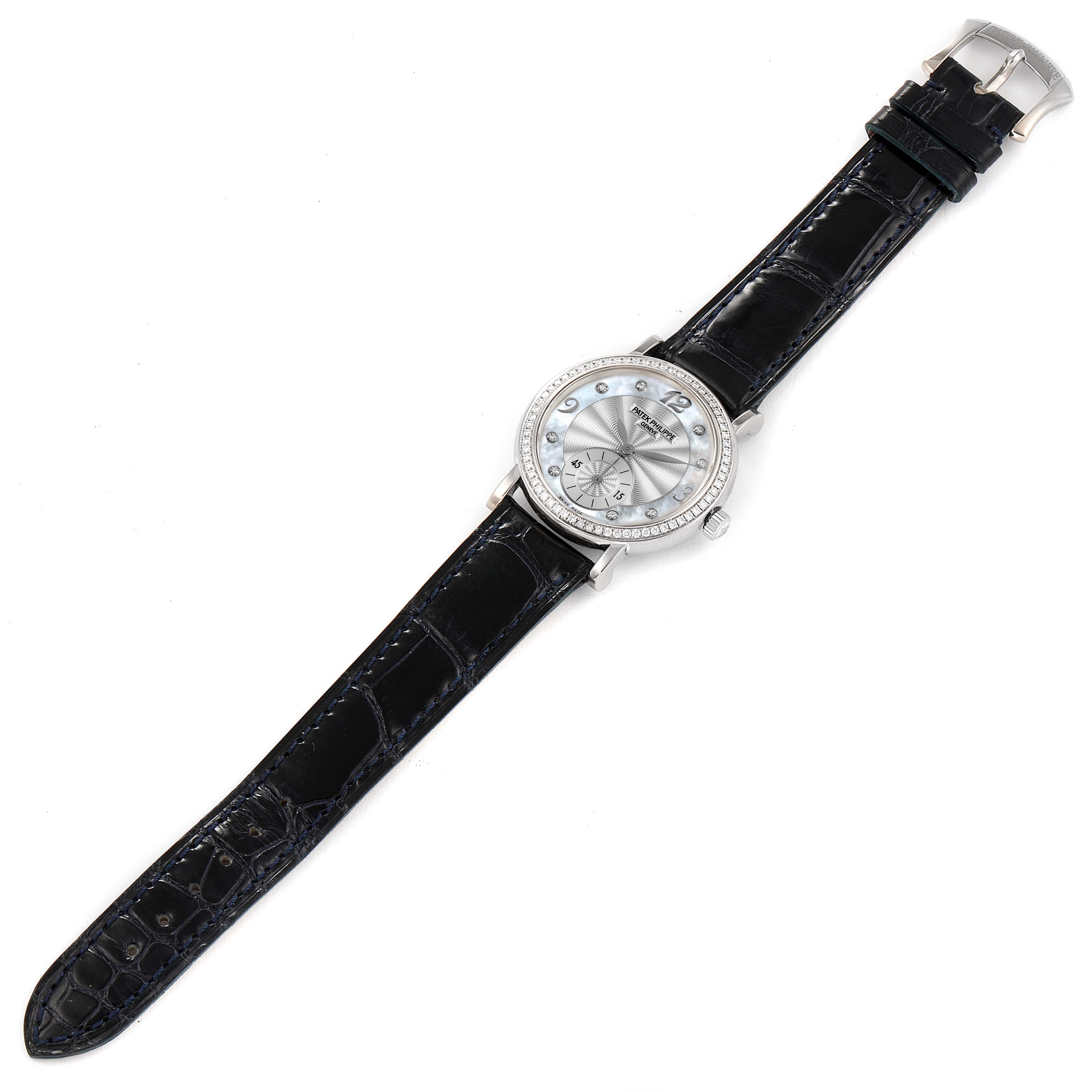 The image shows a Patek Philippe Calatrava 4959G Women's White Gold Mother of Pearl Dial 4959G Women's White Gold Mother of Pearl Dial watch from a top-down angle, featuring its face, black leather strap, and buckle.