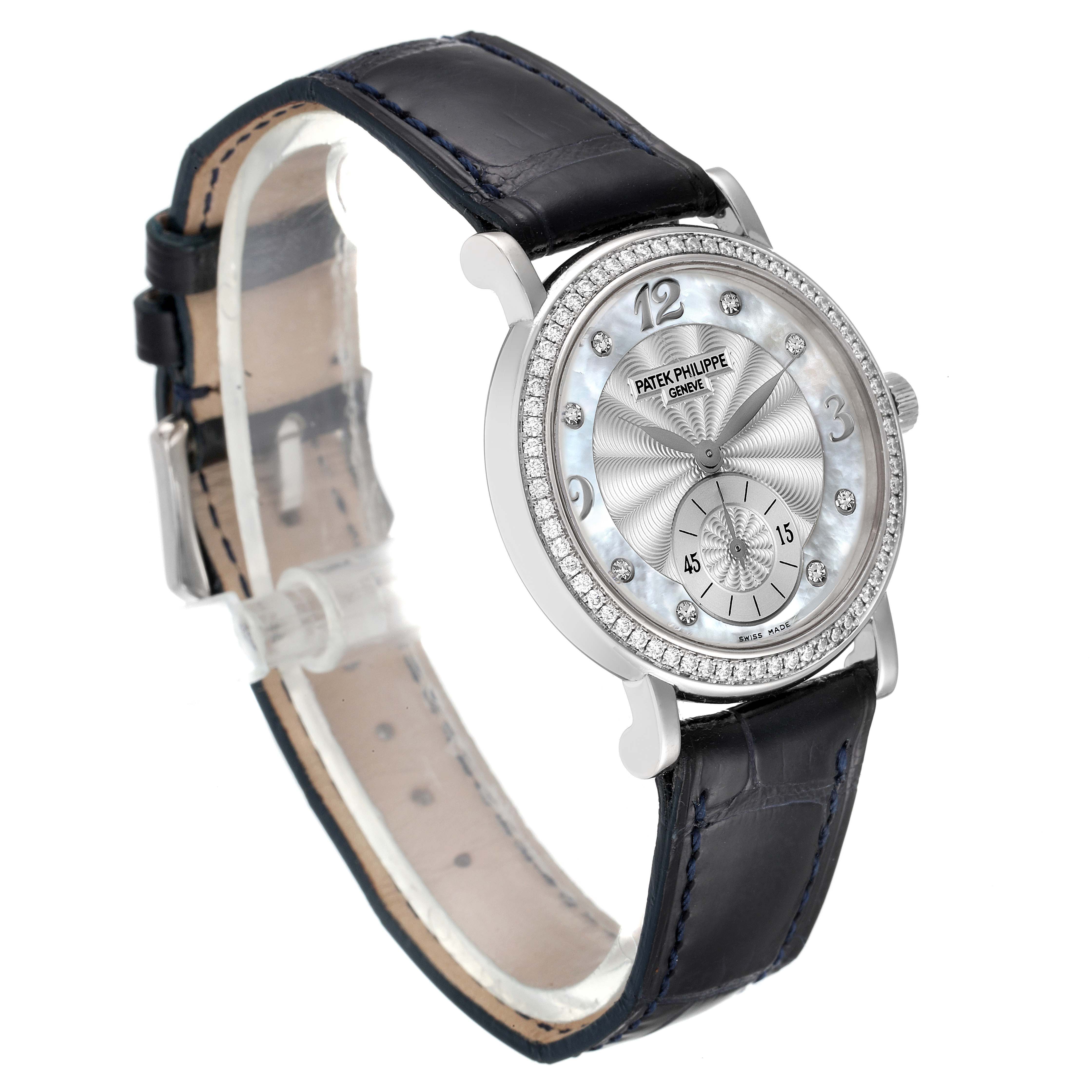 The Patek Philippe Calatrava 4959G Women's White Gold Mother of Pearl Dial 4959G Women's White Gold Mother of Pearl Dial watch is shown from an angled side view, displaying its face, bezel, and leather strap.