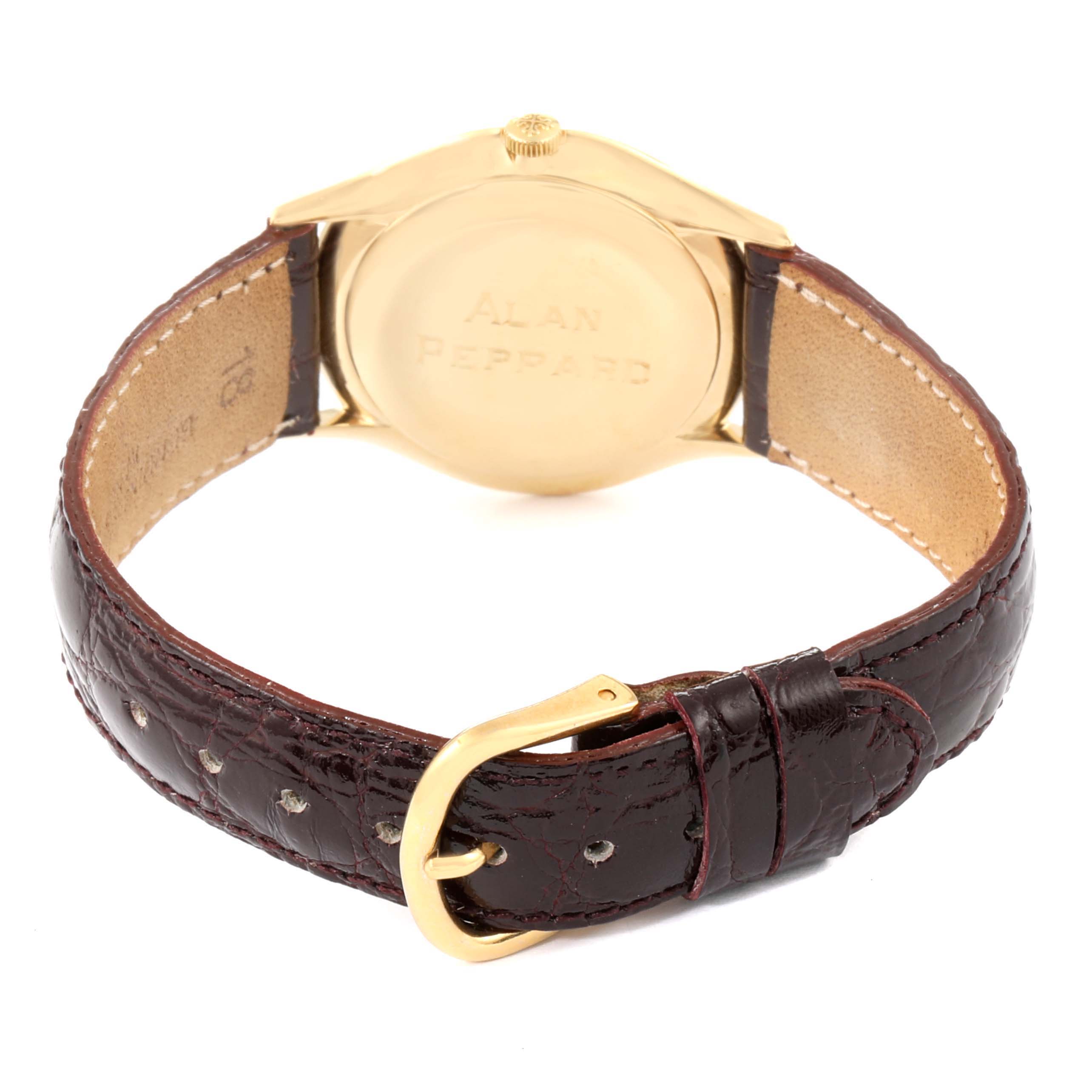 This image shows the backside and strap of a Vintage Patek Philippe watch with a gold case and brown leather strap.