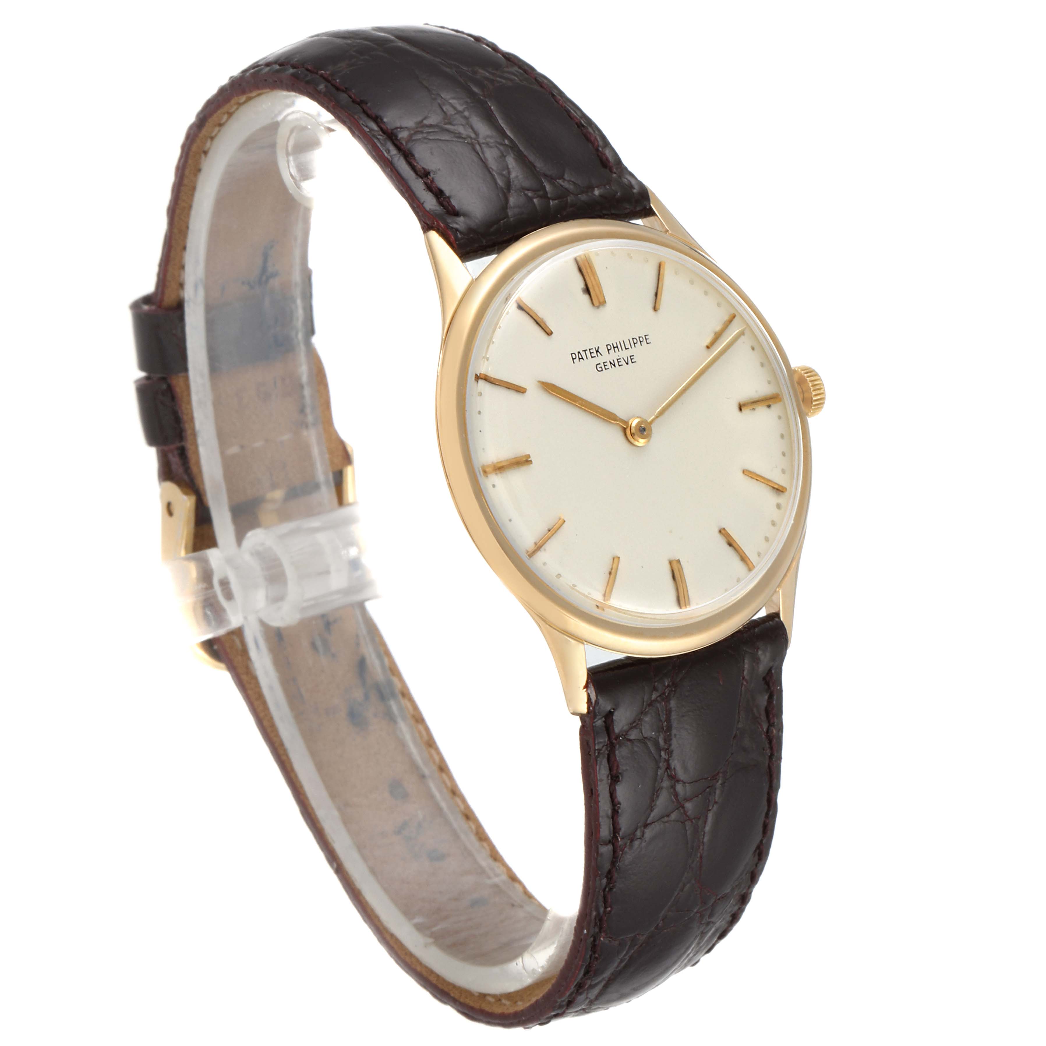 The image shows a front and left side view of a Vintage Patek Philippe watch, featuring a gold case and a dark brown leather strap.